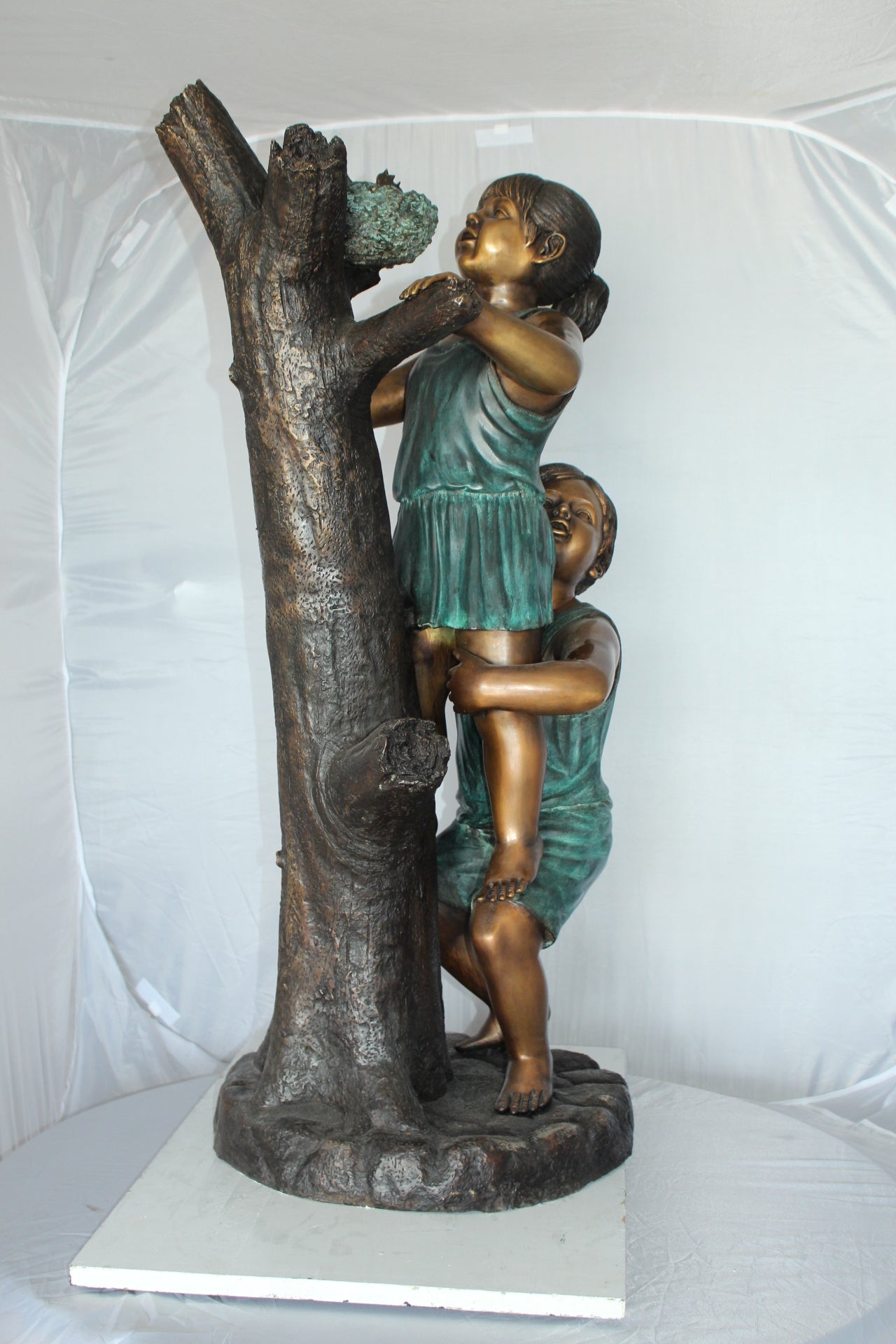 Two Kids Climbing on a Tree Bronze Statue - Size: 17"L x 17"W x 46"H.