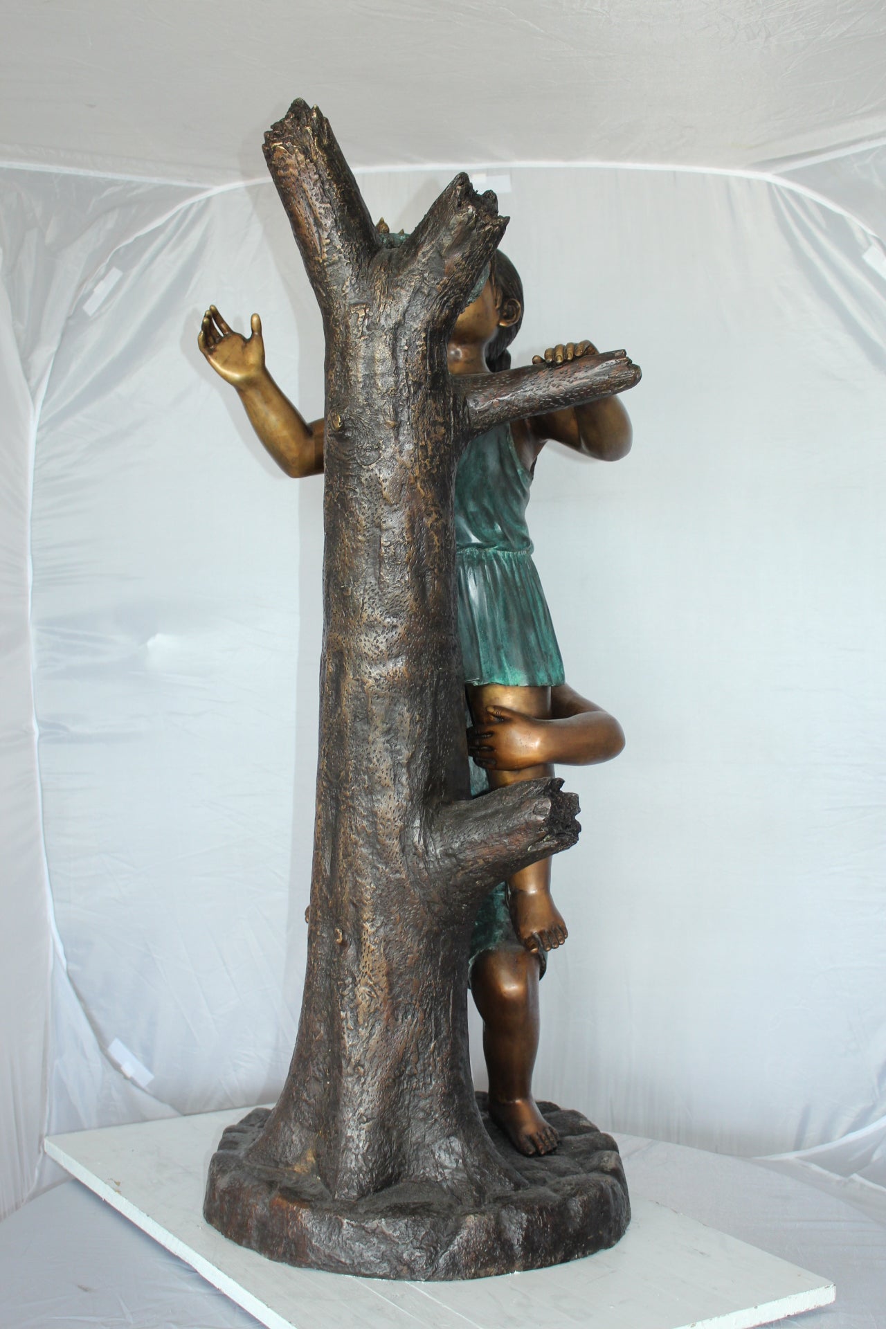 Two Kids Climbing on a Tree Bronze Statue - Size: 17"L x 17"W x 46"H.