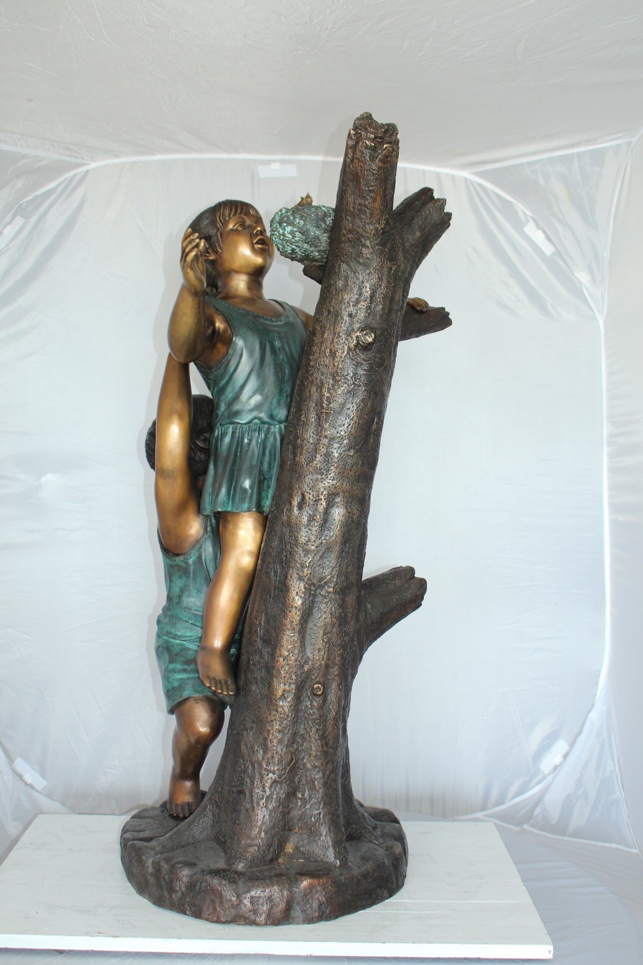 Two Kids Climbing on a Tree Bronze Statue - Size: 17"L x 17"W x 46"H.