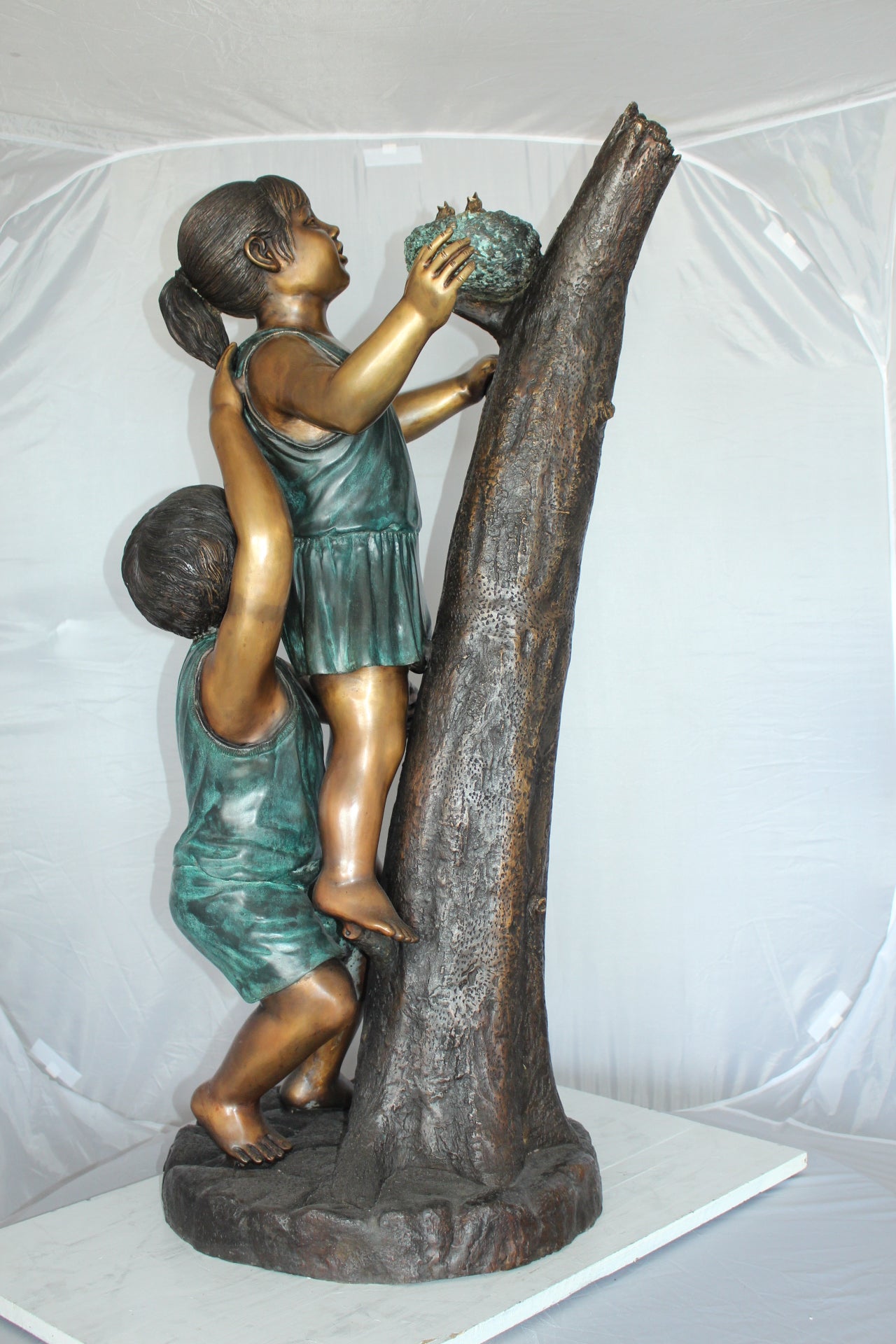 Two Kids Climbing on a Tree Bronze Statue - Size: 17"L x 17"W x 46"H.