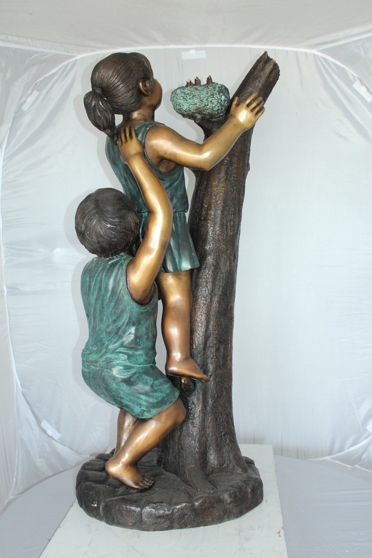 Two Kids Climbing on a Tree Bronze Statue - Size: 17"L x 17"W x 46"H.