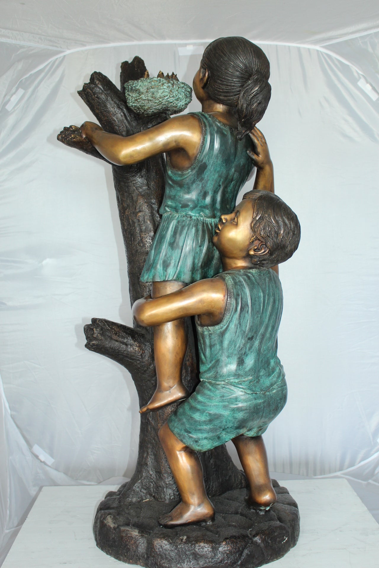 Two Kids Climbing on a Tree Bronze Statue - Size: 17"L x 17"W x 46"H.