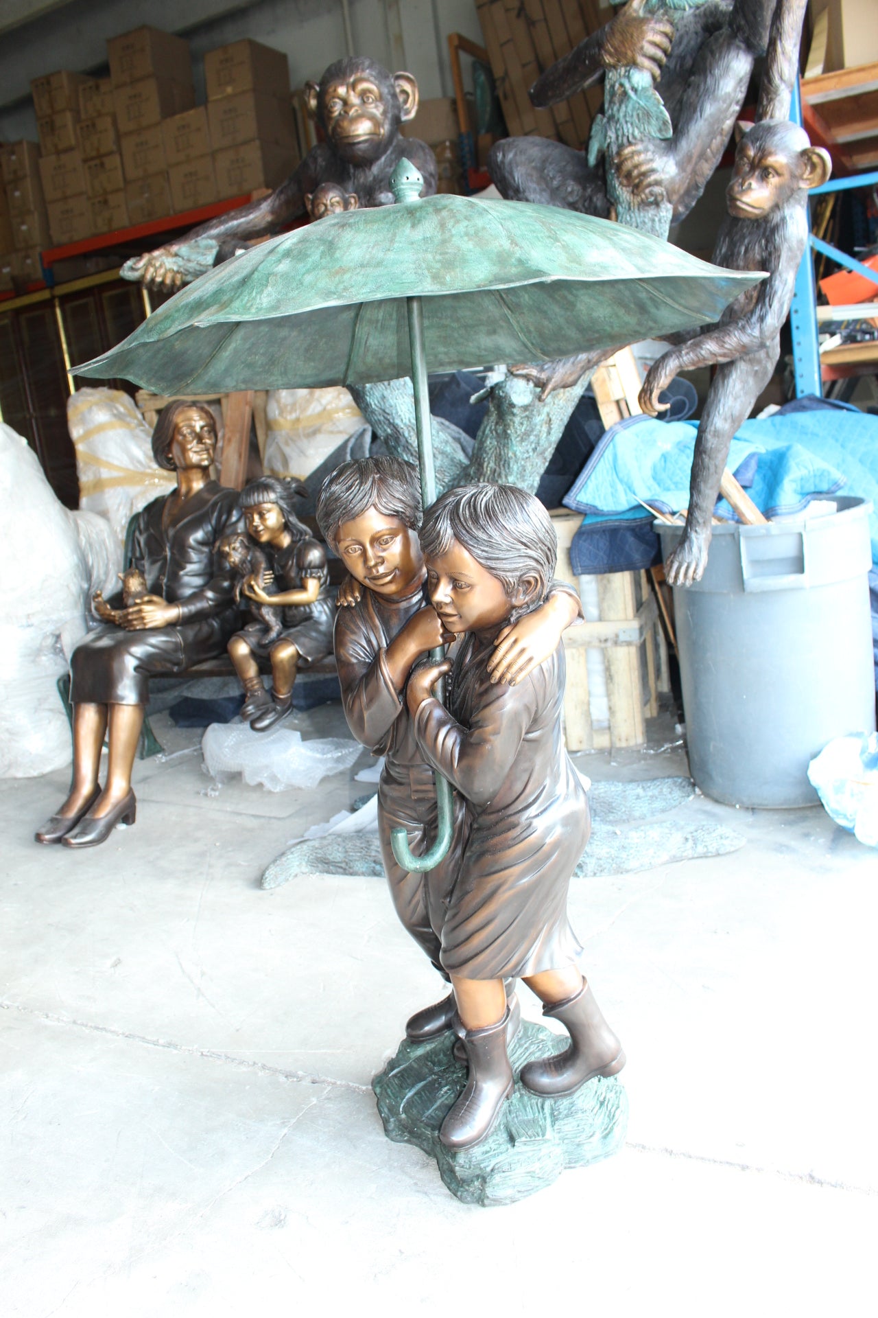 Two Kids Holding an Umbrella - Bronze Statue - Fountain - 90"L x 34"W x 90"H.