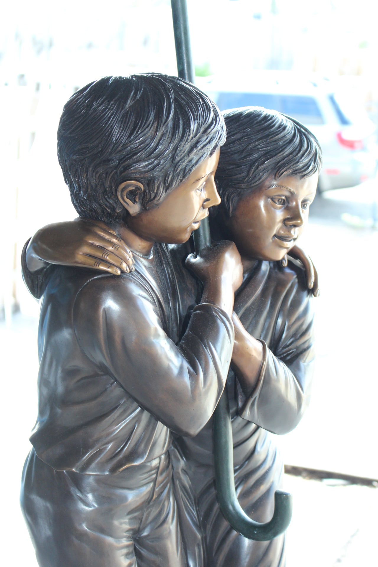 Two Kids Holding an Umbrella - Bronze Statue - Fountain - 90"L x 34"W x 90"H.