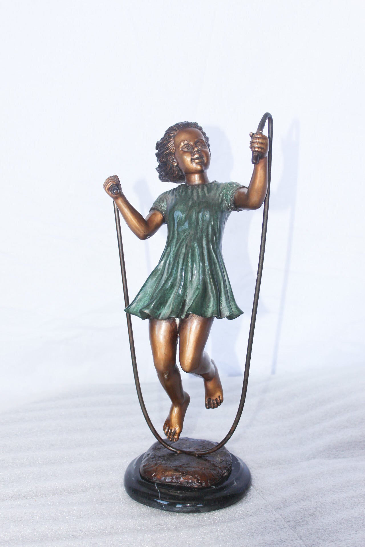 Young girl jump roping bronze statue - Size: 5"L x 7"W x 15"H.