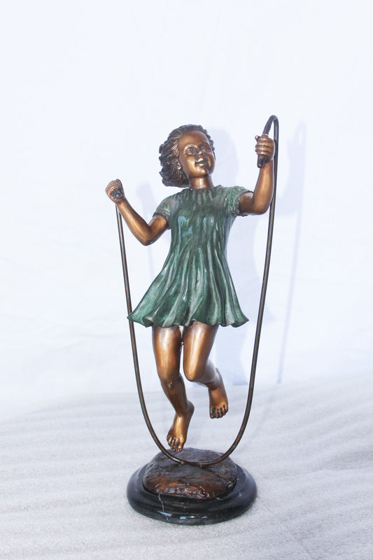 Young girl jump roping bronze statue -  Size: 5"L x 7"W x 15"H.