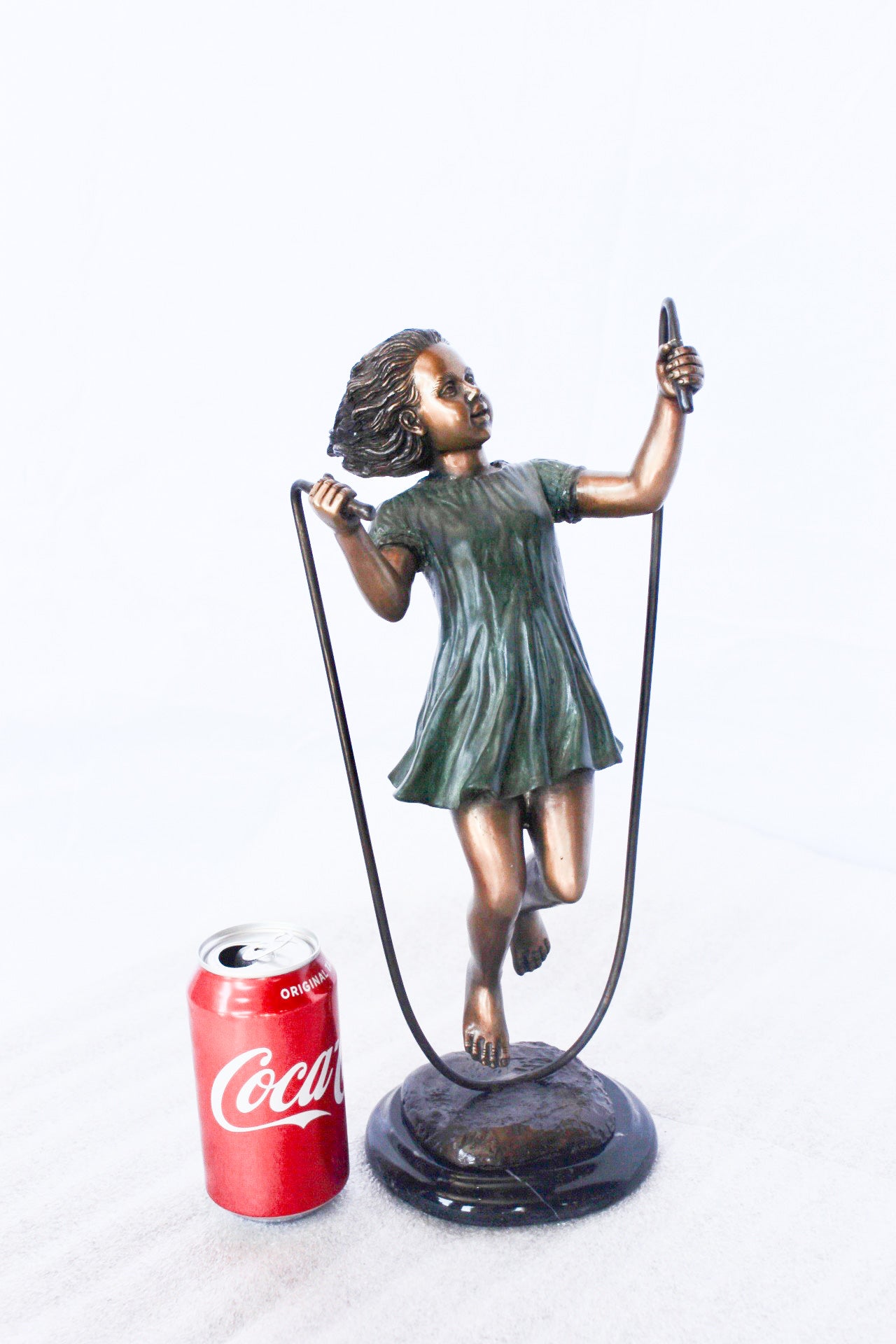 Young girl jump roping bronze statue -  Size: 5"L x 7"W x 15"H.