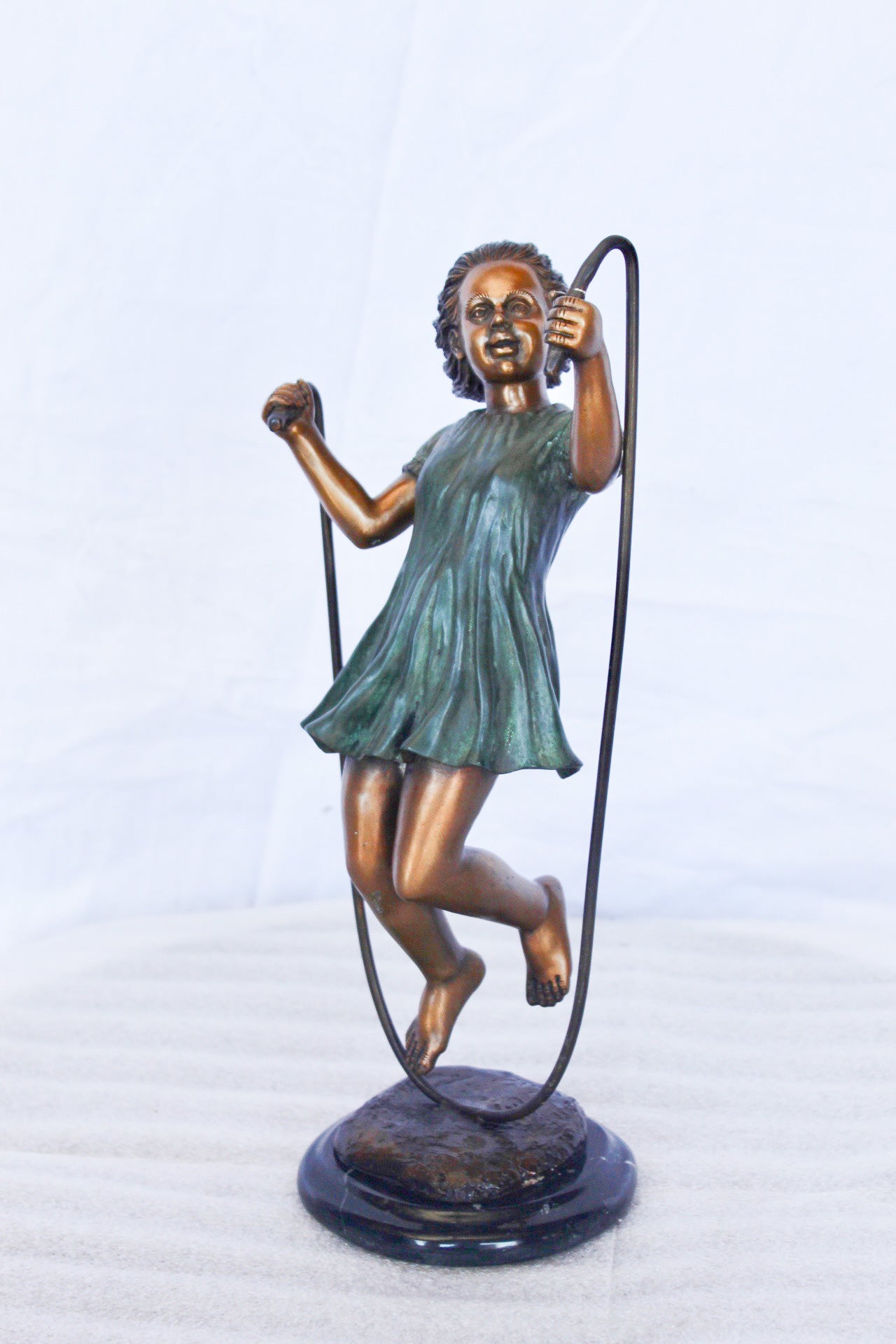 Young girl jump roping bronze statue - Size: 5"L x 7"W x 15"H.