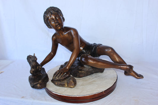 Adventurous boy with squirrel bronze statue -  Size: 36"L x 18"W x 22"H.