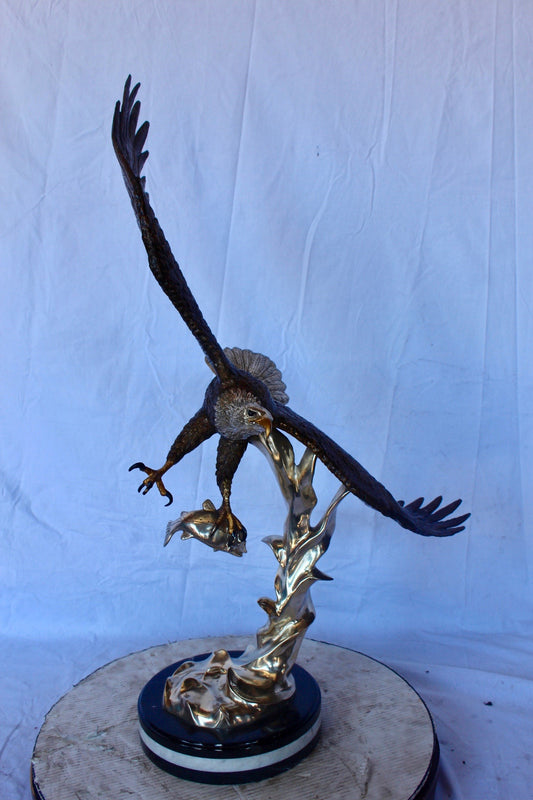 Soaring eagle carrying prey bronze statue - Size: 16"L x 23"W x 39"H.