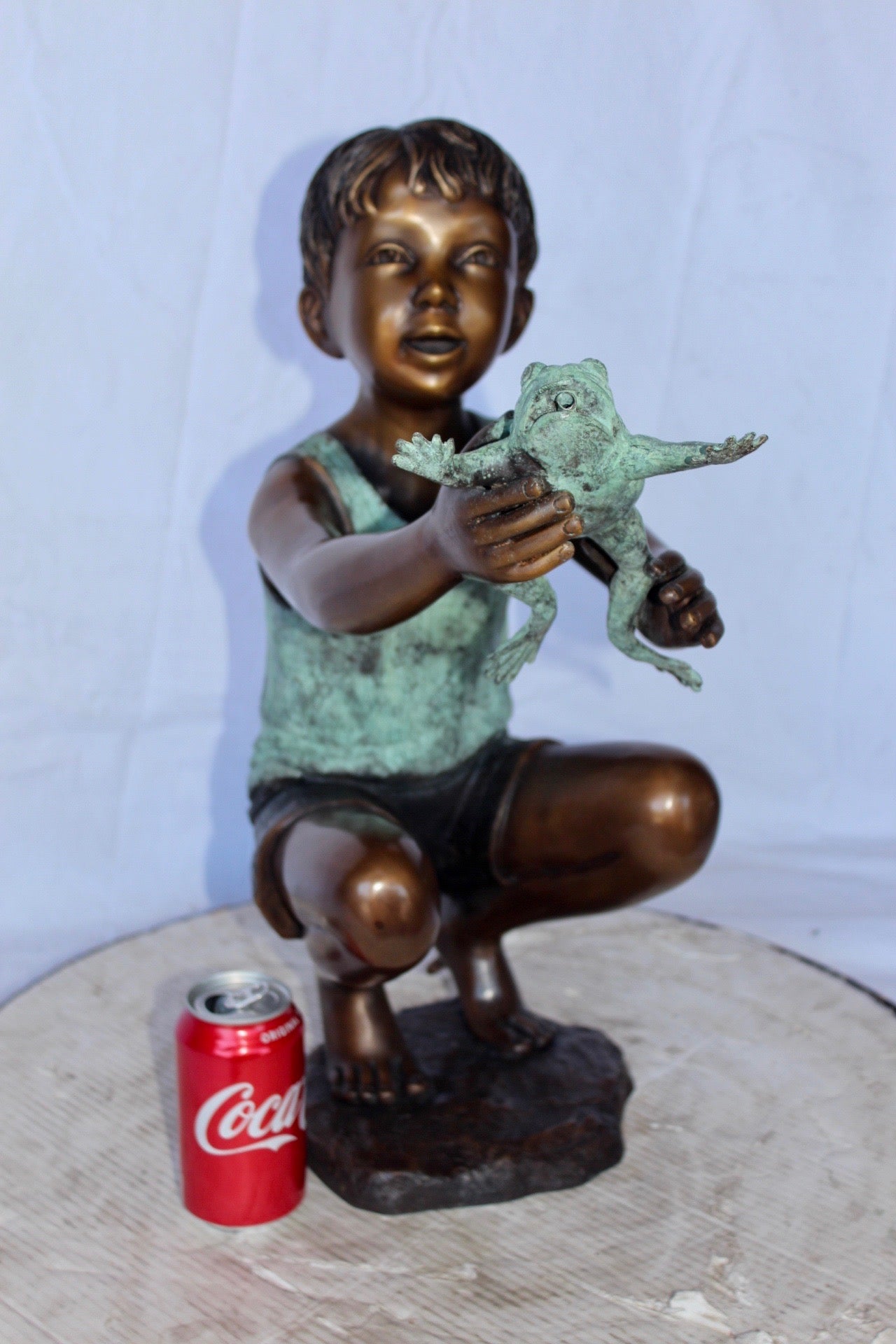 Young boy holding a frog bronze statue fountain - Size: 18"L x 10"W x 22"H.
