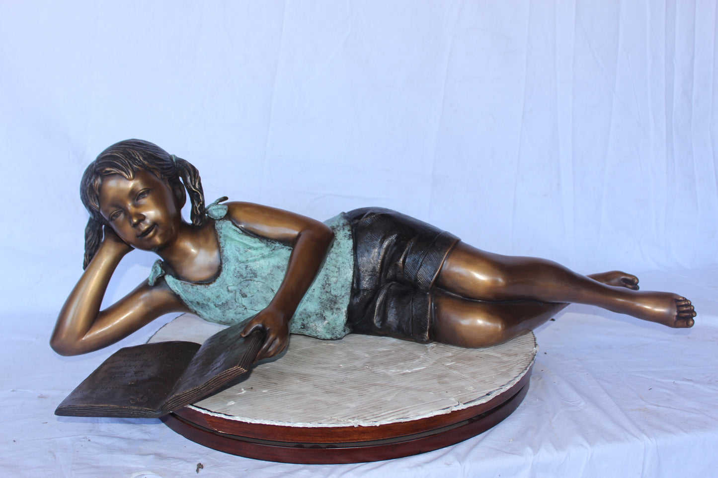 Nifao Bronze Girl Reading on Ground Statue – Hand-Cast Lost Wax Outdoor Sculpture with Book, Patina Finish - 40" L x 17" W x 13" H.