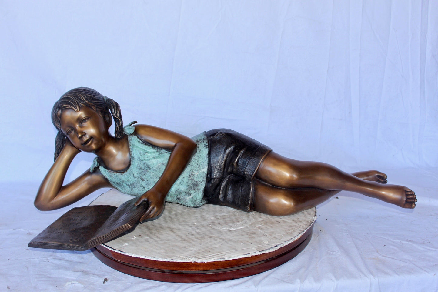 Nifao Bronze Girl Reading on Ground Statue – Hand-Cast Lost Wax Outdoor Sculpture with Book, Patina Finish - 40" L x 17" W x 13" H.