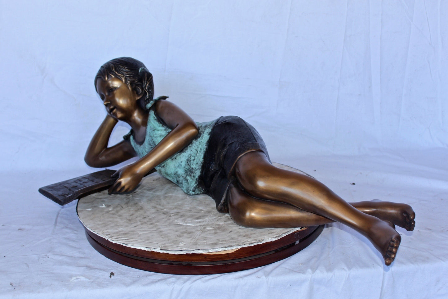 Nifao Bronze Girl Reading on Ground Statue – Hand-Cast Lost Wax Outdoor Sculpture with Book, Patina Finish - 40" L x 17" W x 13" H.
