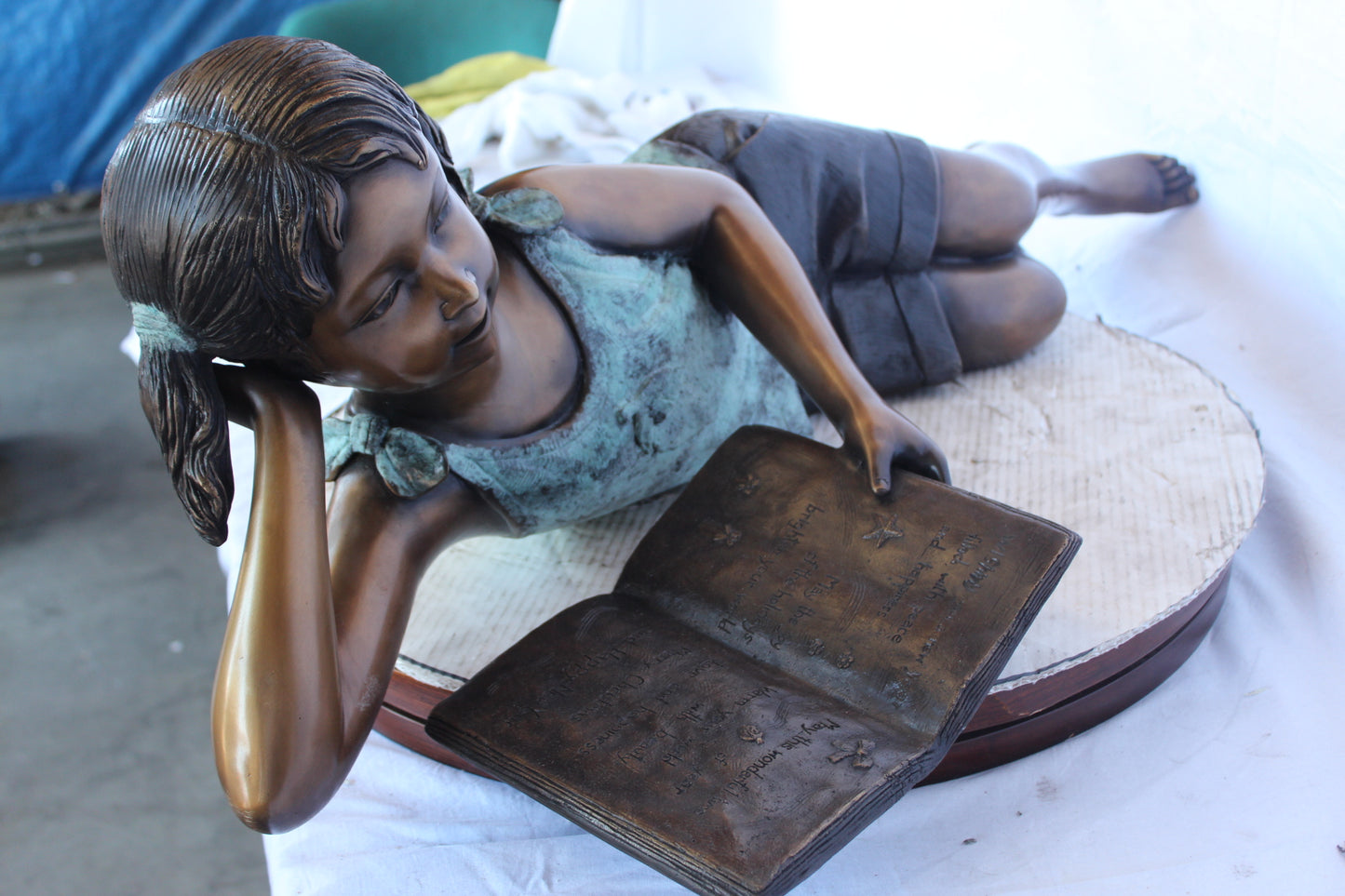 Nifao Bronze Girl Reading on Ground Statue – Hand-Cast Lost Wax Outdoor Sculpture with Book, Patina Finish - 40" L x 17" W x 13" H.