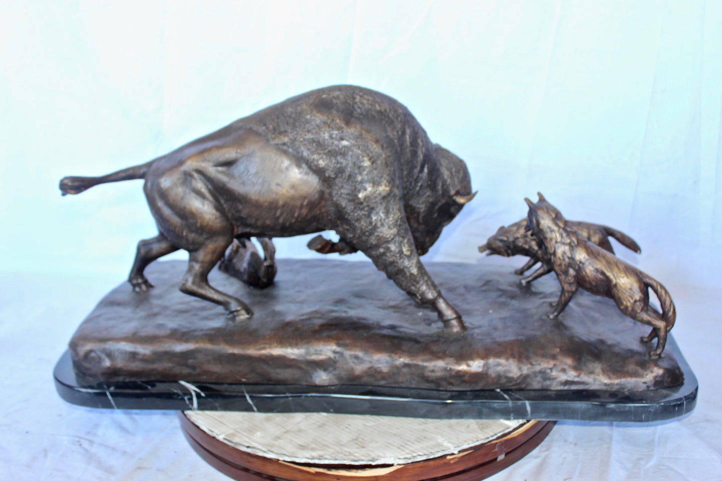 Charging bison v. Wolves bronze statue -  Size: 36"L x 17"W x 17"H.