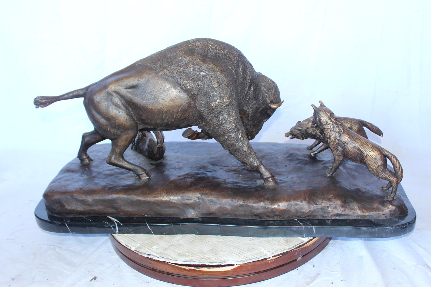 Charging bison v. Wolves bronze statue -  Size: 36"L x 17"W x 17"H.