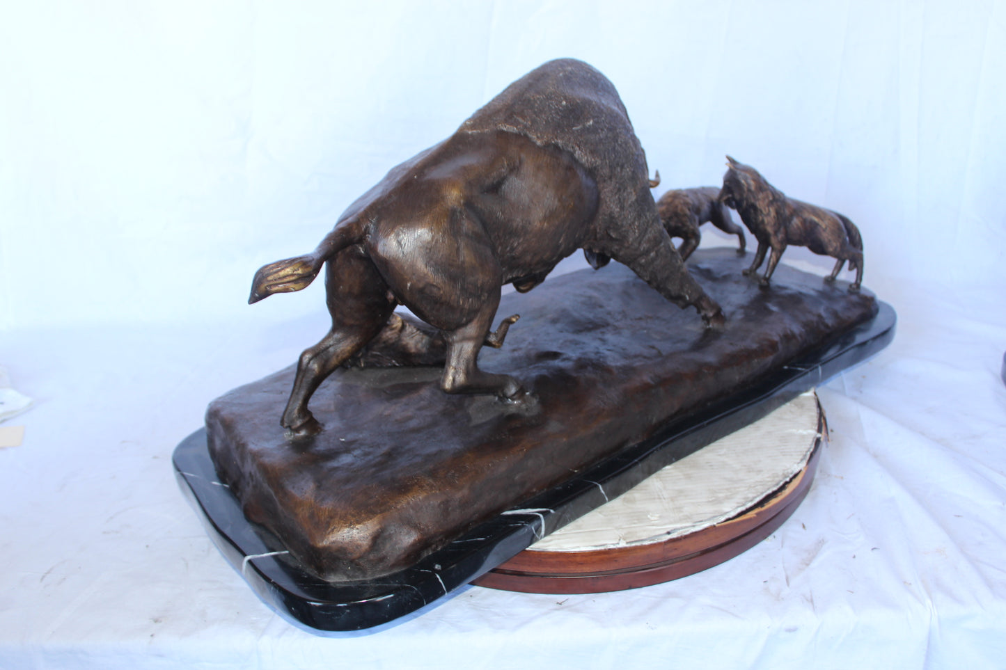 Charging bison v. Wolves bronze statue -  Size: 36"L x 17"W x 17"H.