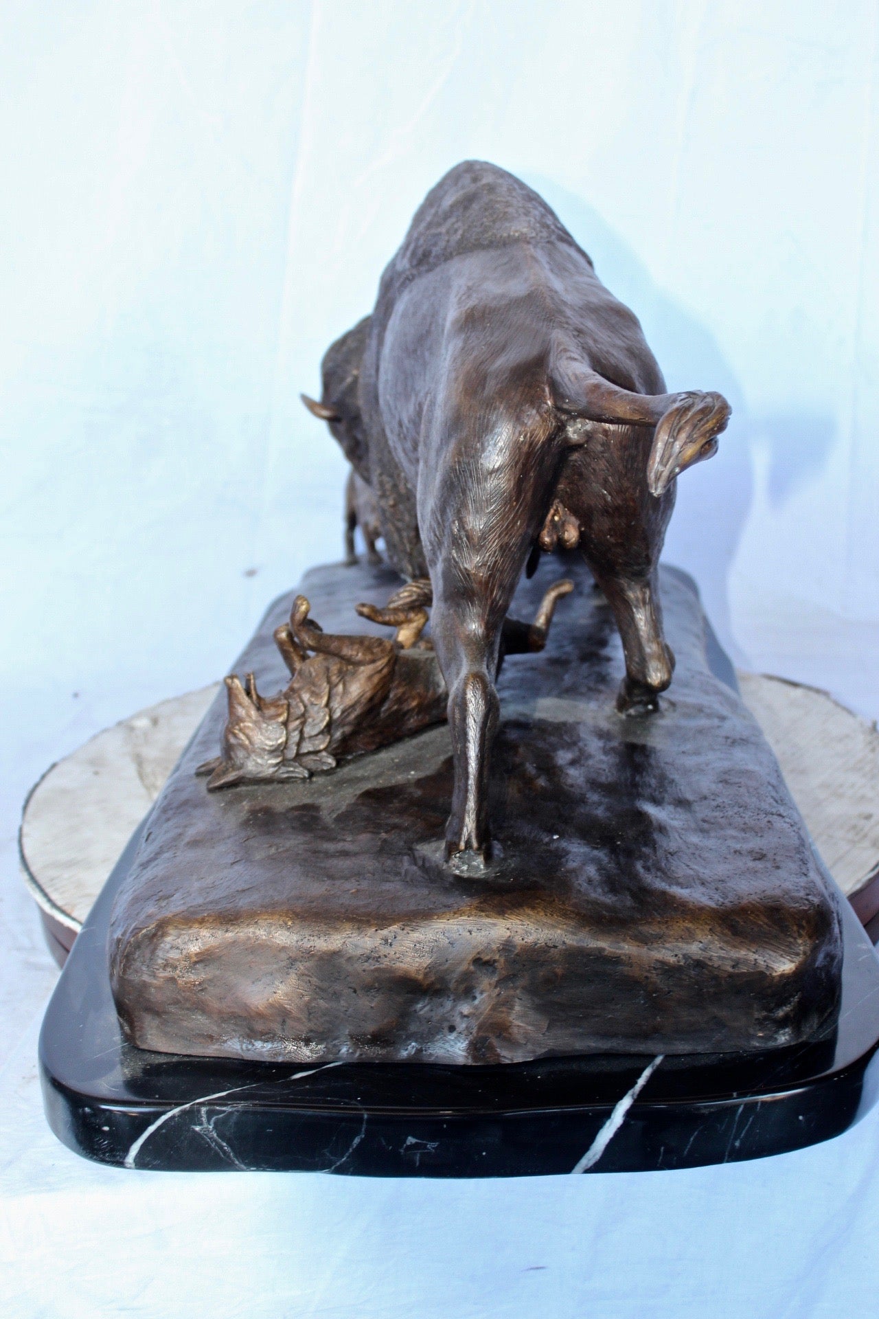 Charging bison v. Wolves bronze statue -  Size: 36"L x 17"W x 17"H.