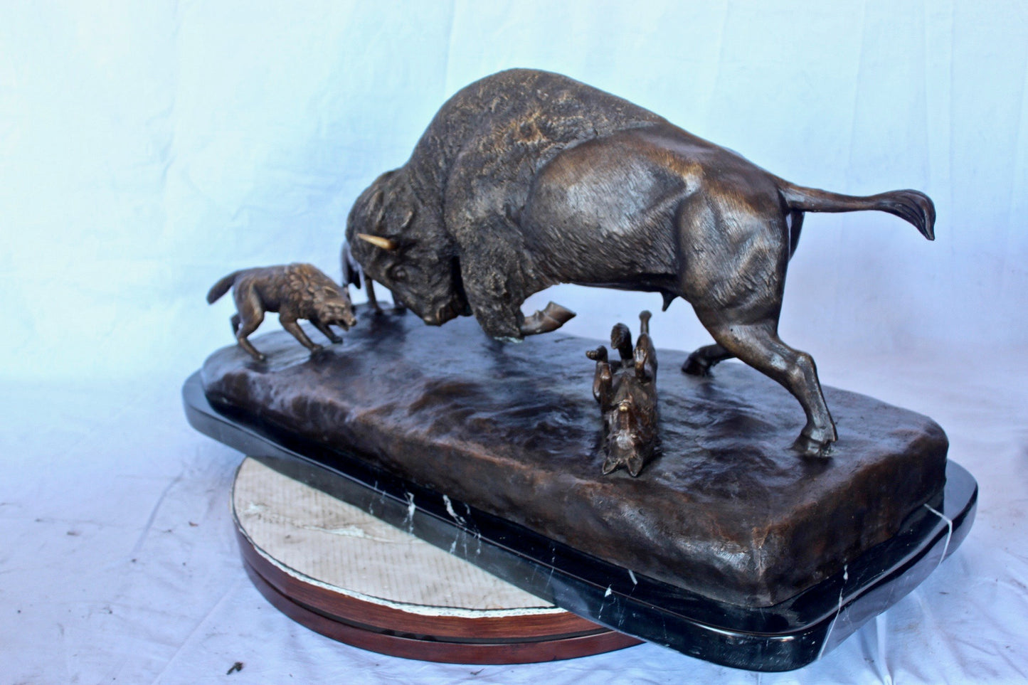 Charging bison v. Wolves bronze statue -  Size: 36"L x 17"W x 17"H.