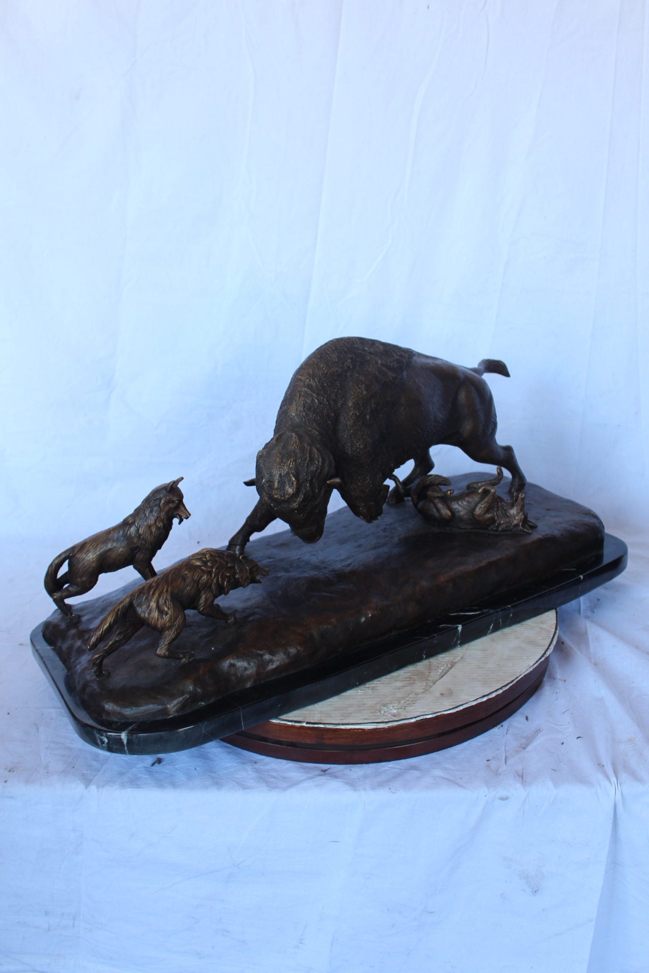 Charging bison v. Wolves bronze statue -  Size: 36"L x 17"W x 17"H.