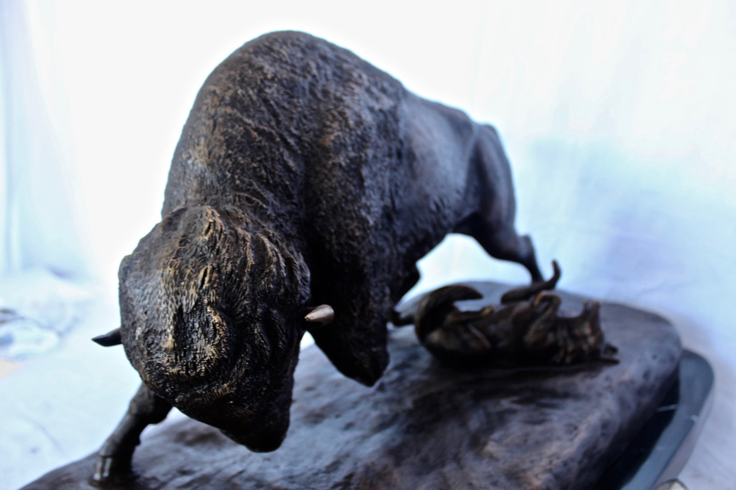 Charging bison v. Wolves bronze statue - Size: 36"L x 17"W x 17"H.
