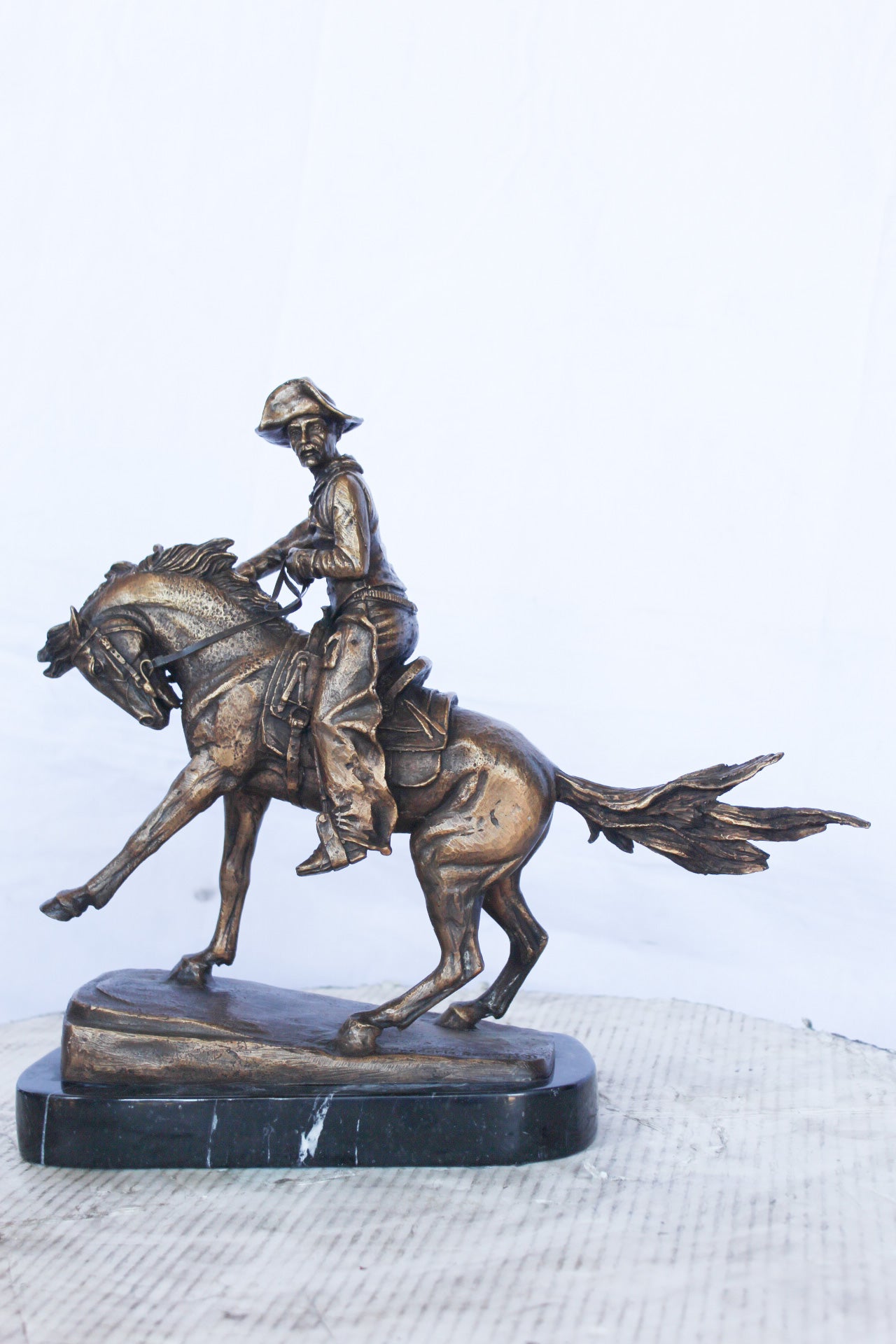 Remington replica Cowboy bronze statue - Size: 5"L x 15"W x 13"H.