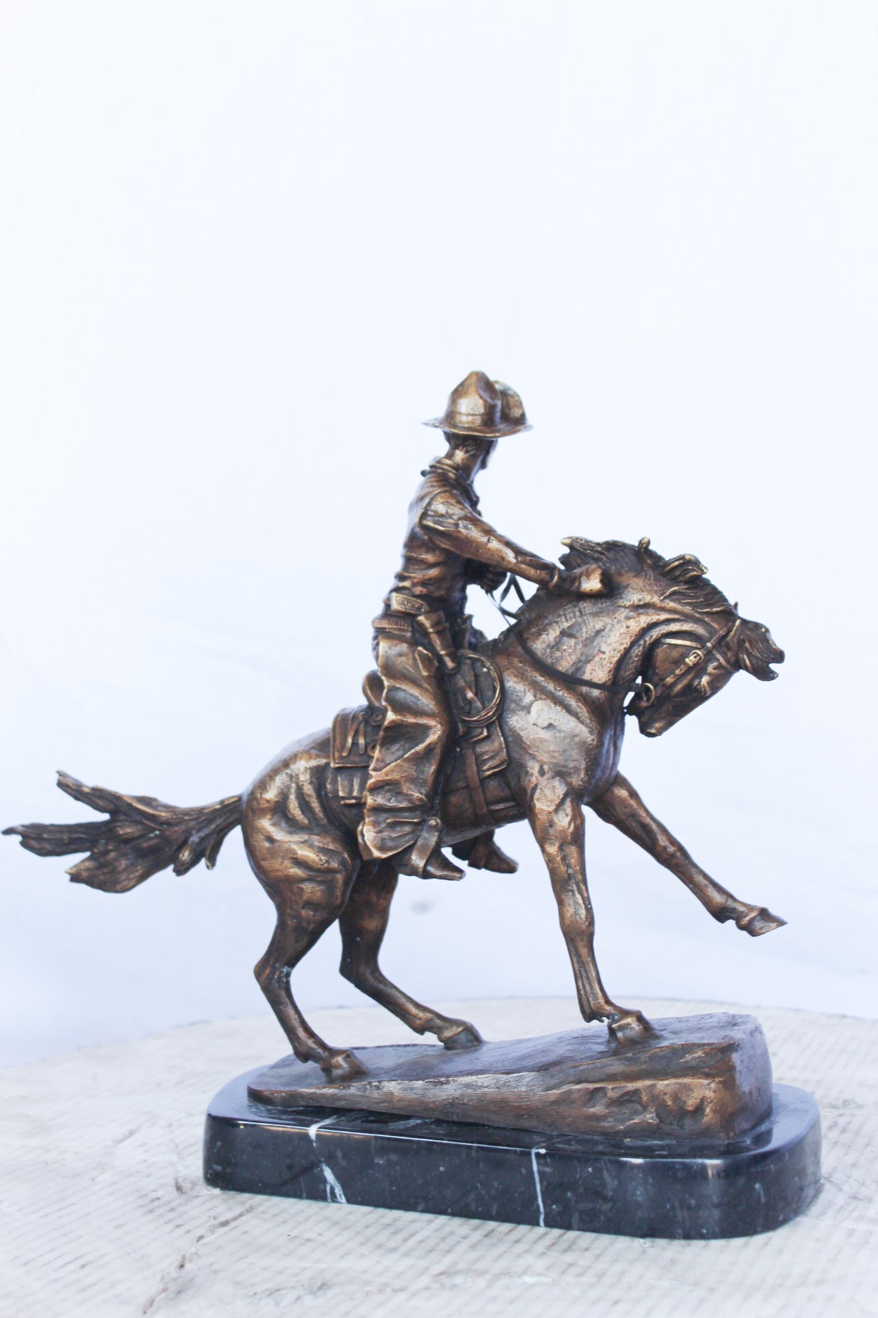 Remington replica Cowboy bronze statue - Size: 5"L x 15"W x 13"H.