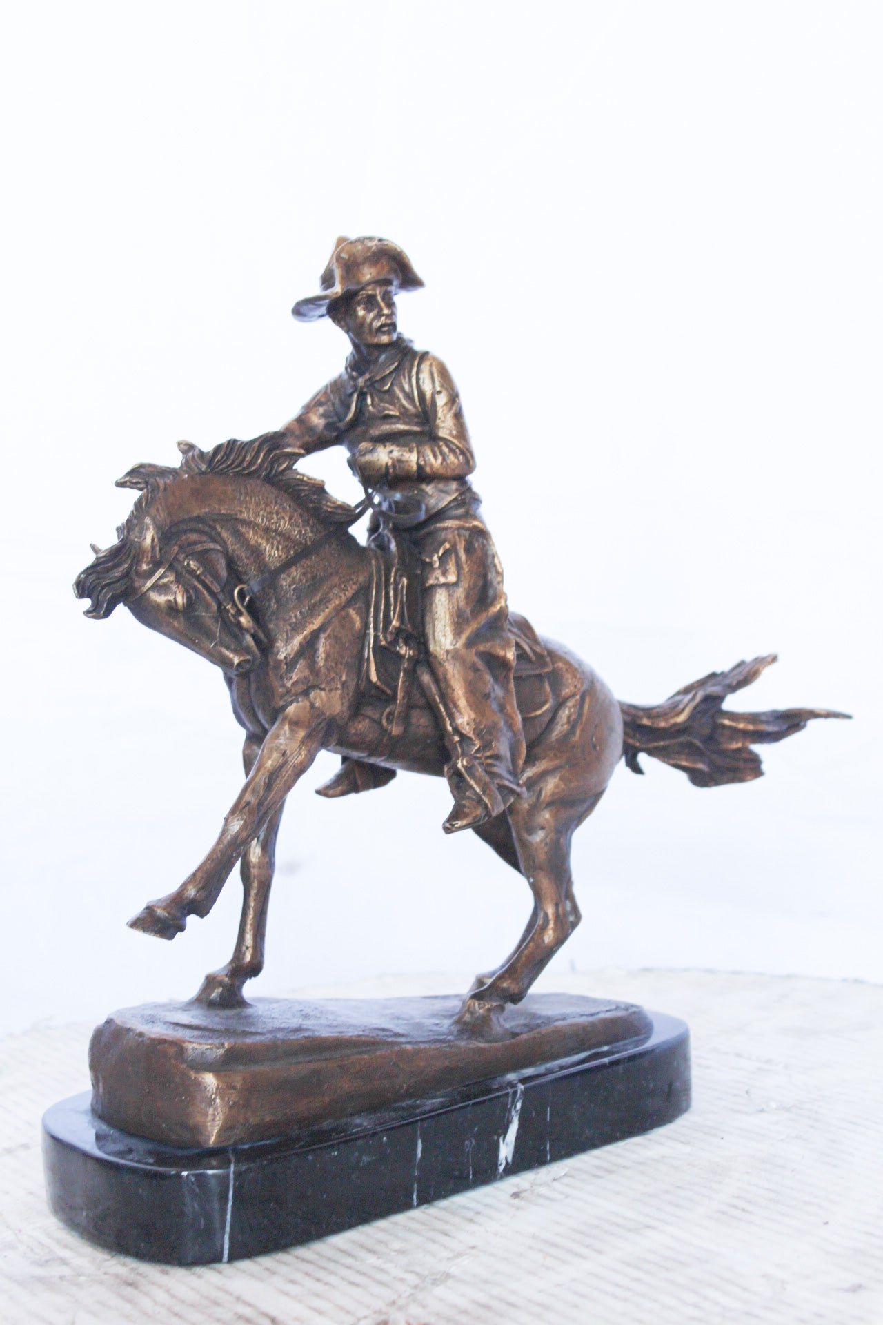 Remington replica Cowboy bronze statue - Size: 5"L x 15"W x 13"H.