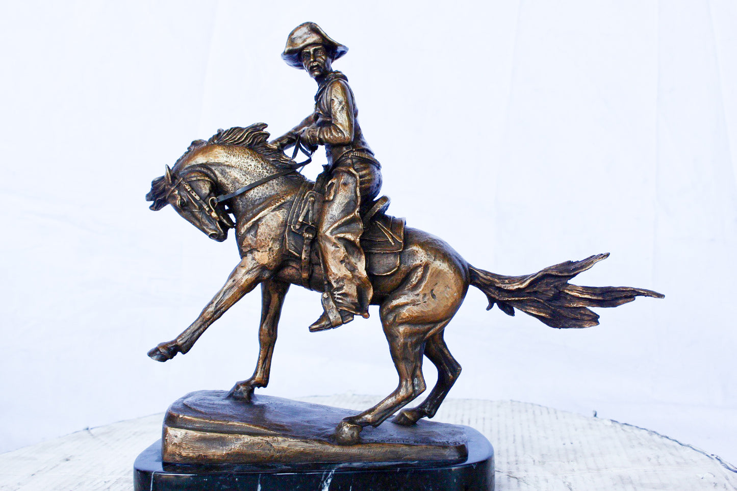 Remington replica Cowboy bronze statue - Size: 5"L x 15"W x 13"H.