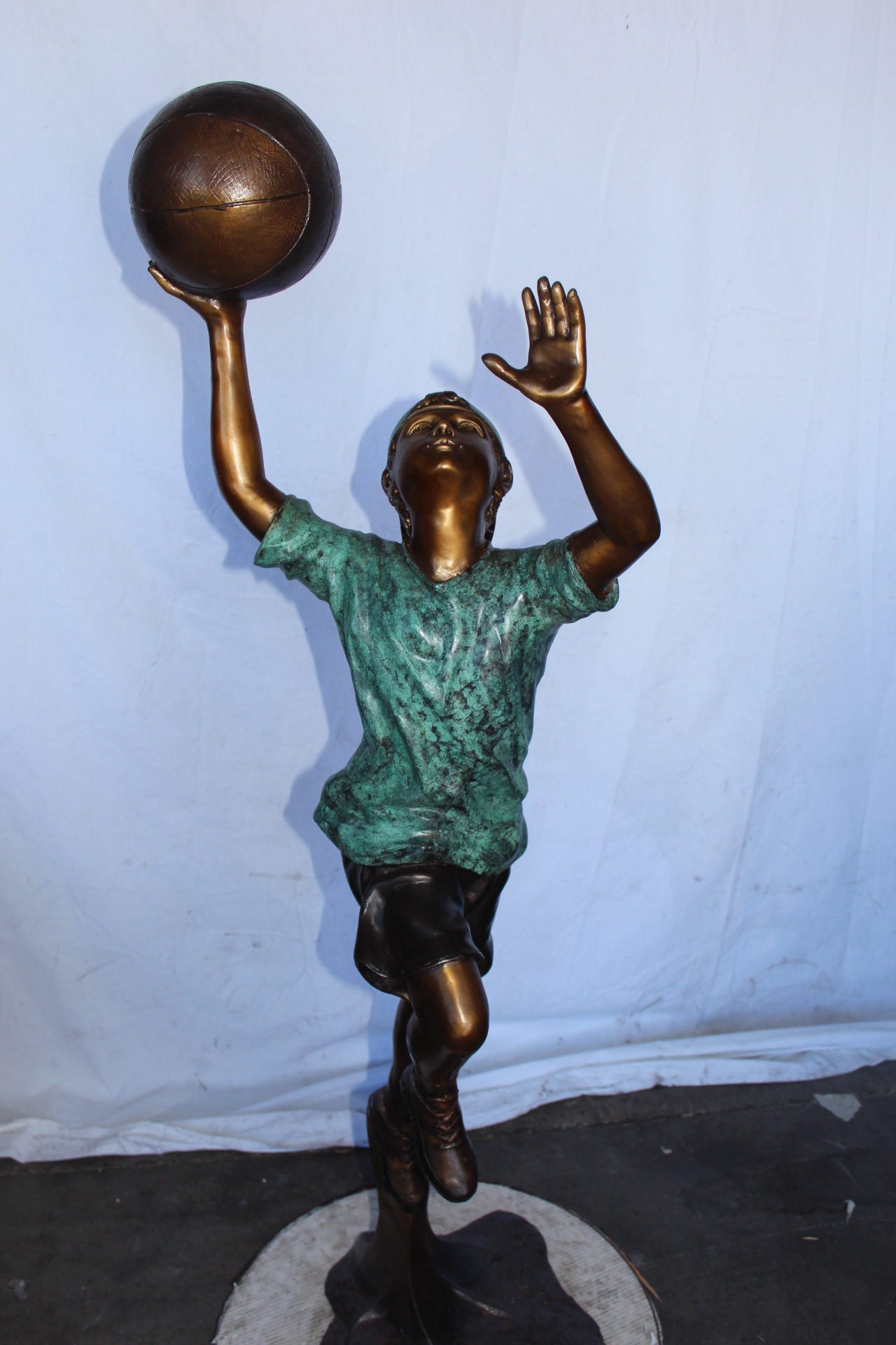 A young boy scoring a basket bronze statue -  Size: 19"L x 20"W x 61"H.
