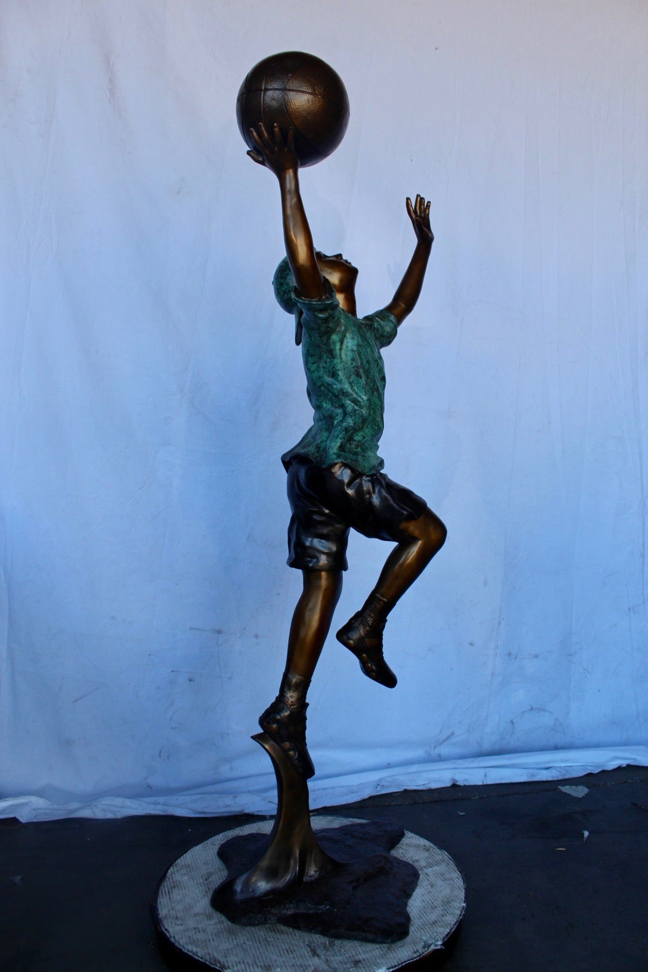 A young boy scoring a basket bronze statue -  Size: 19"L x 20"W x 61"H.