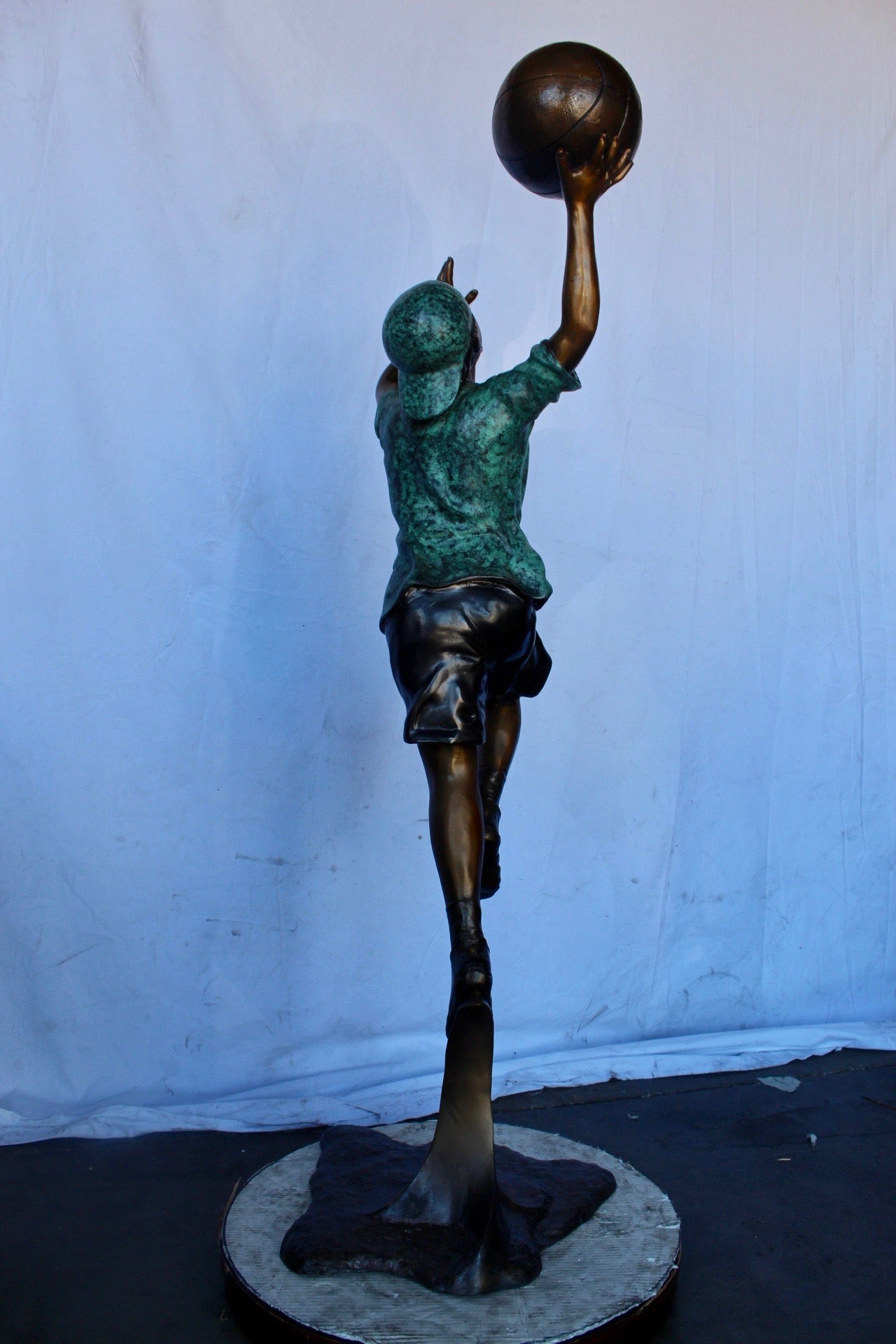 A young boy scoring a basket bronze statue -  Size: 19"L x 20"W x 61"H.