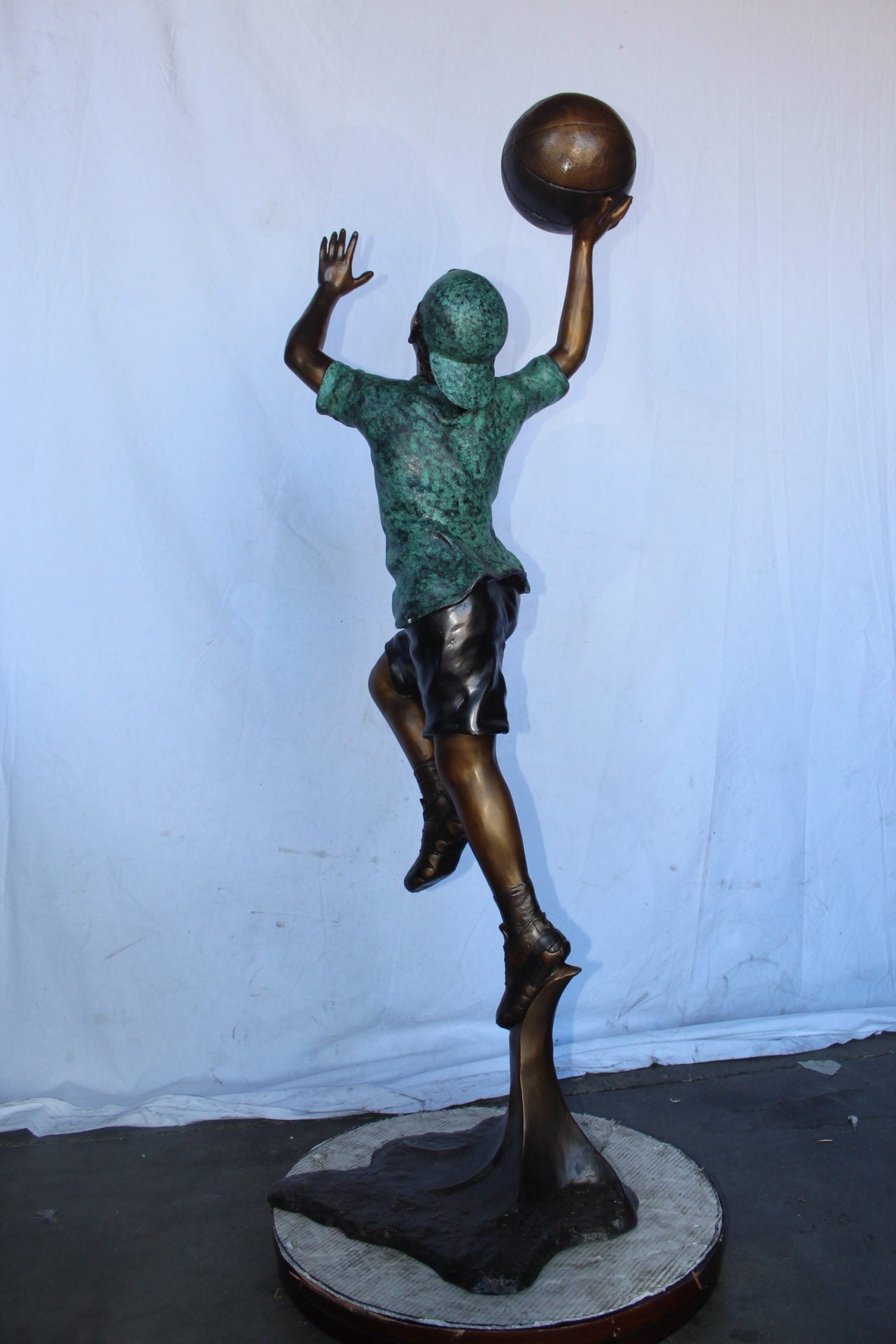 A young boy scoring a basket bronze statue -  Size: 19"L x 20"W x 61"H.