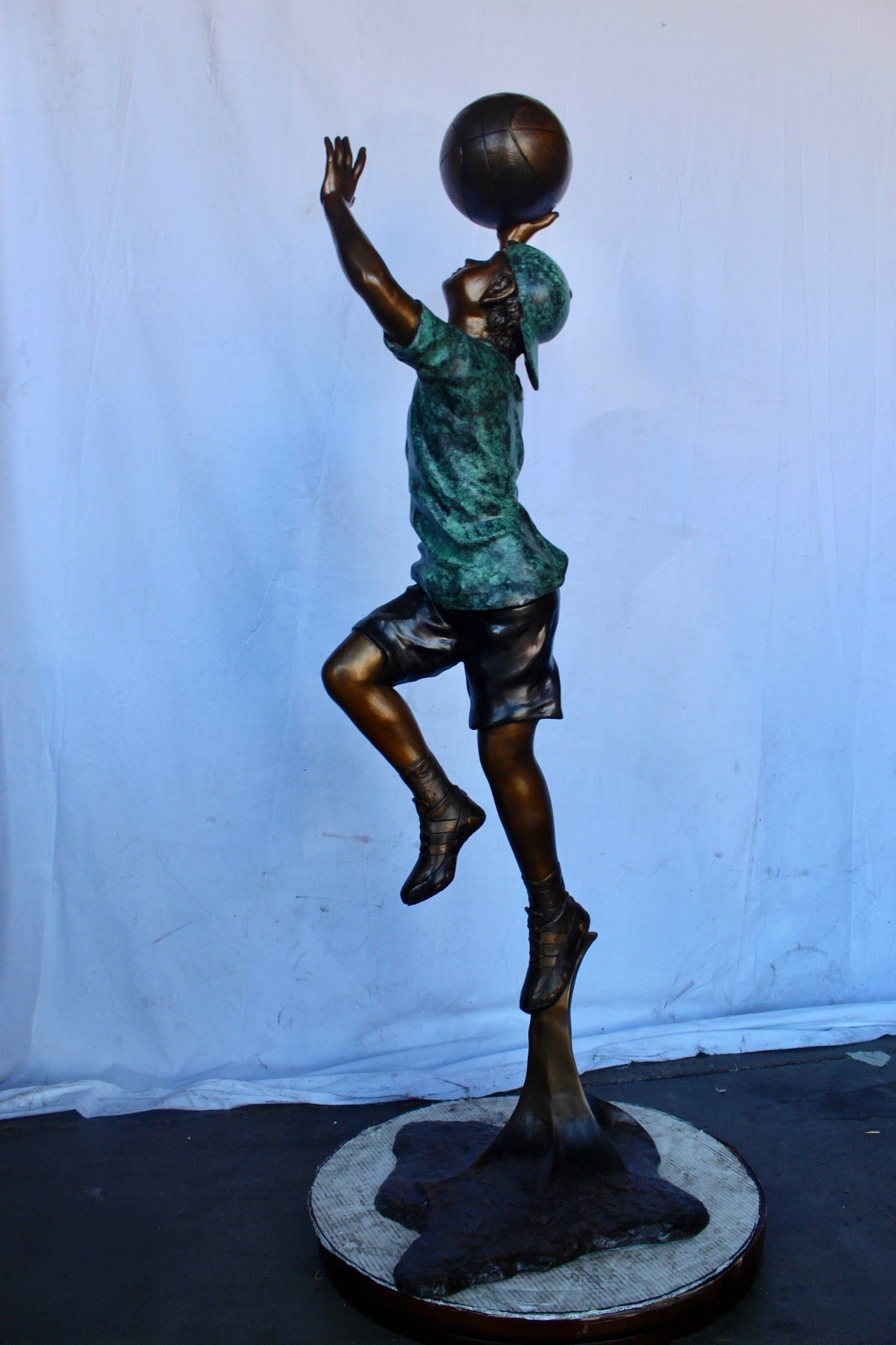 A young boy scoring a basket bronze statue -  Size: 19"L x 20"W x 61"H.