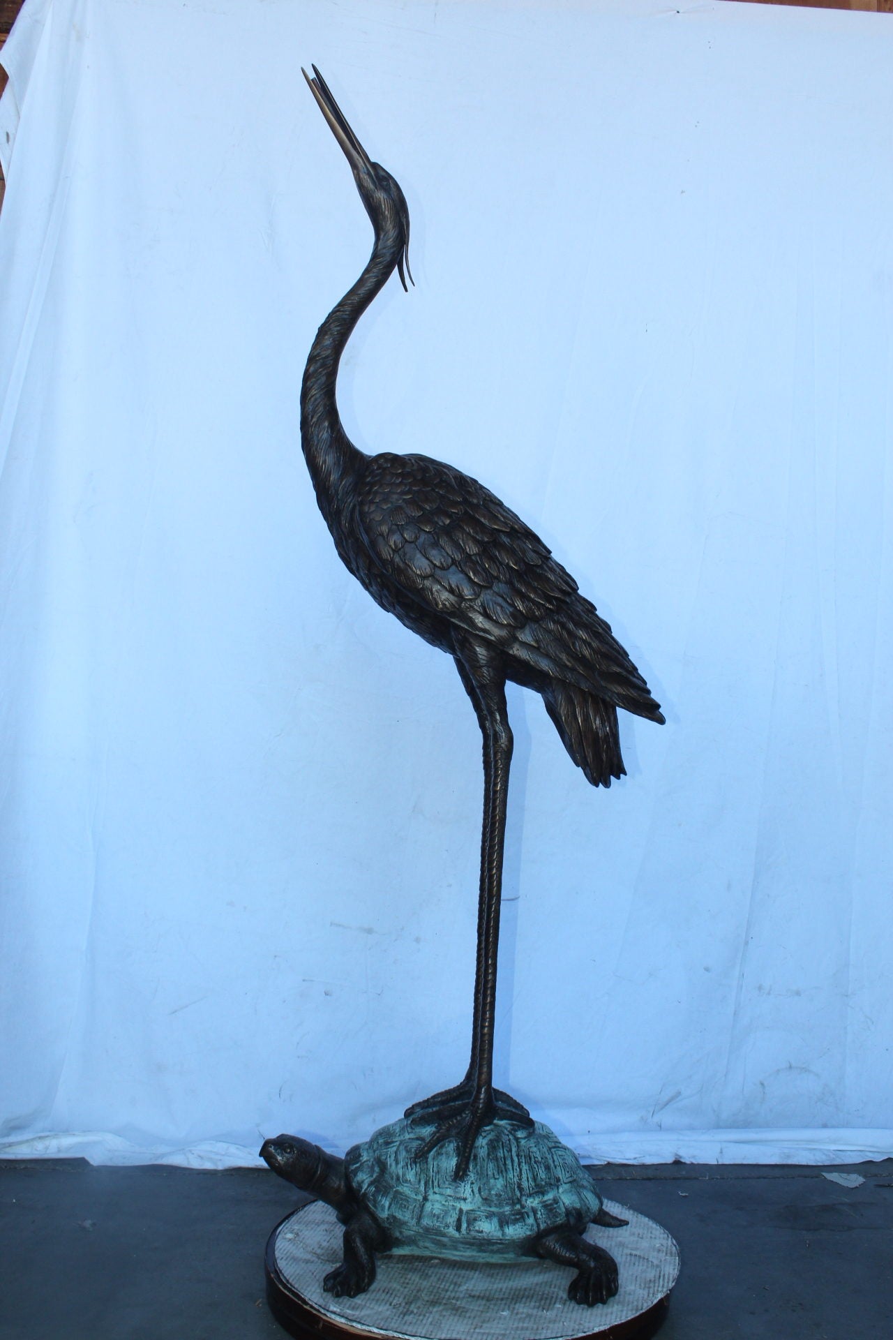 Blue Heron looking up on turtle bronze statue fountain Size: 21" x 16" x 71"H.