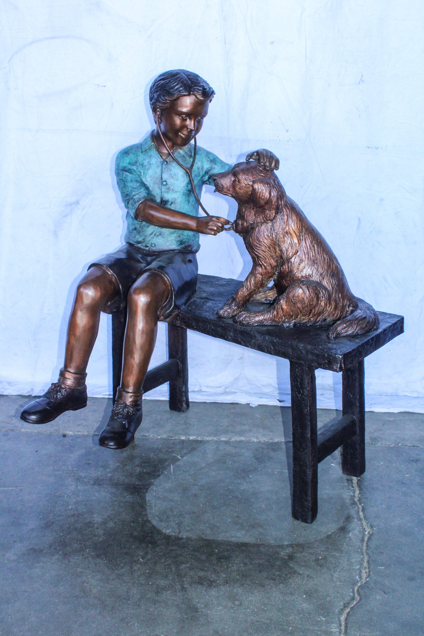 Boy Playing Veterinary Doctor with Dog on a Bench Bronze Statue 34" x 24" x 42"H