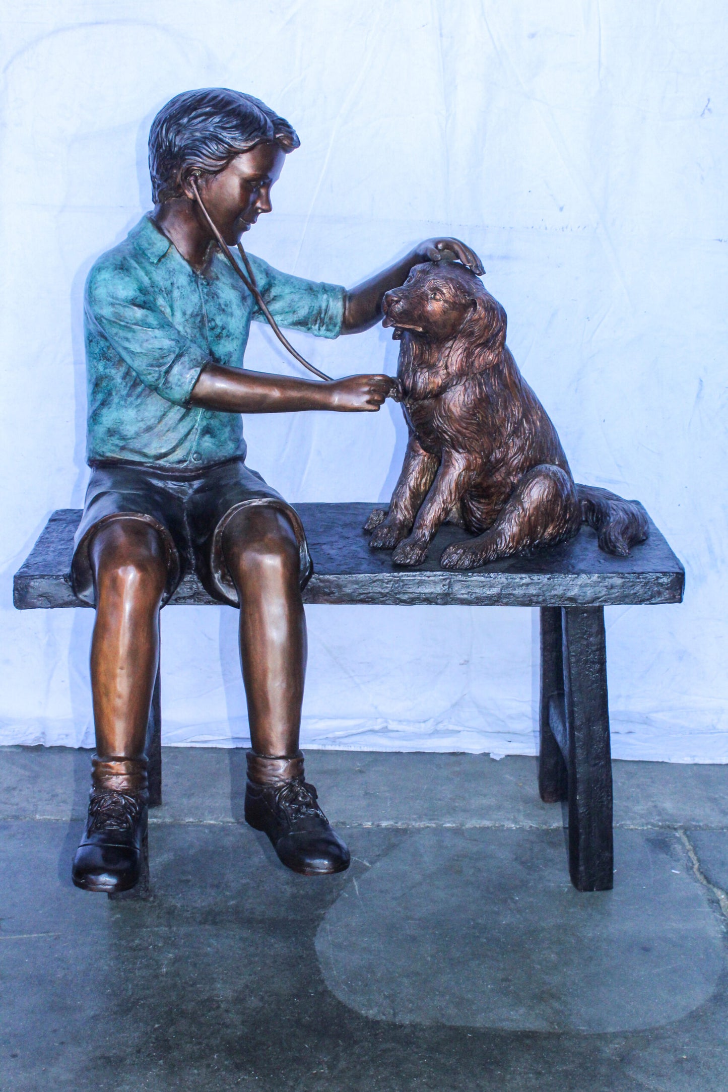 Boy Playing Veterinary Doctor with Dog on a Bench Bronze Statue 34" x 24" x 42"H