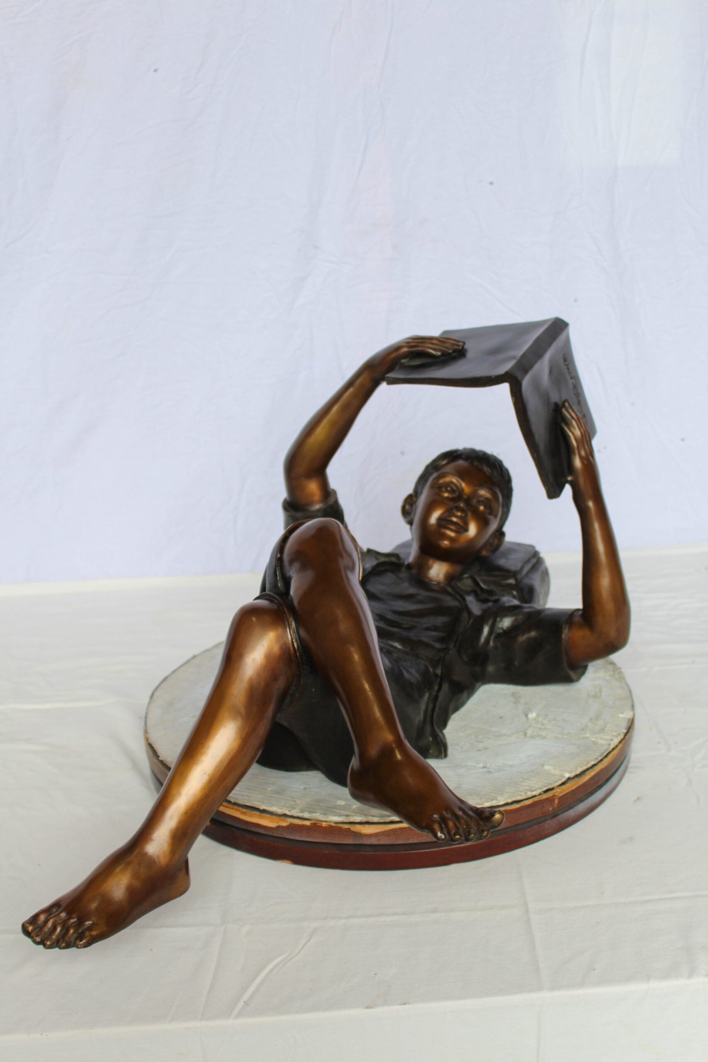 Nifao Bronze Boy Reading Statue – Large Handcrafted Lost Wax Sculpture of Young Boy Lying Back with Book – Detailed Child Figurine for Study, Library, Garden, or Home Déco 41" x 22" x 18"H
