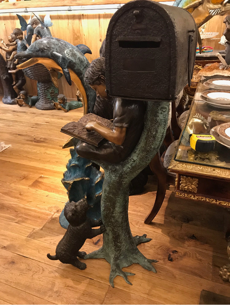 Boy Sitting by a Mailbox reading a book Bronze Statue - 16"L x 20"W x 50"H.