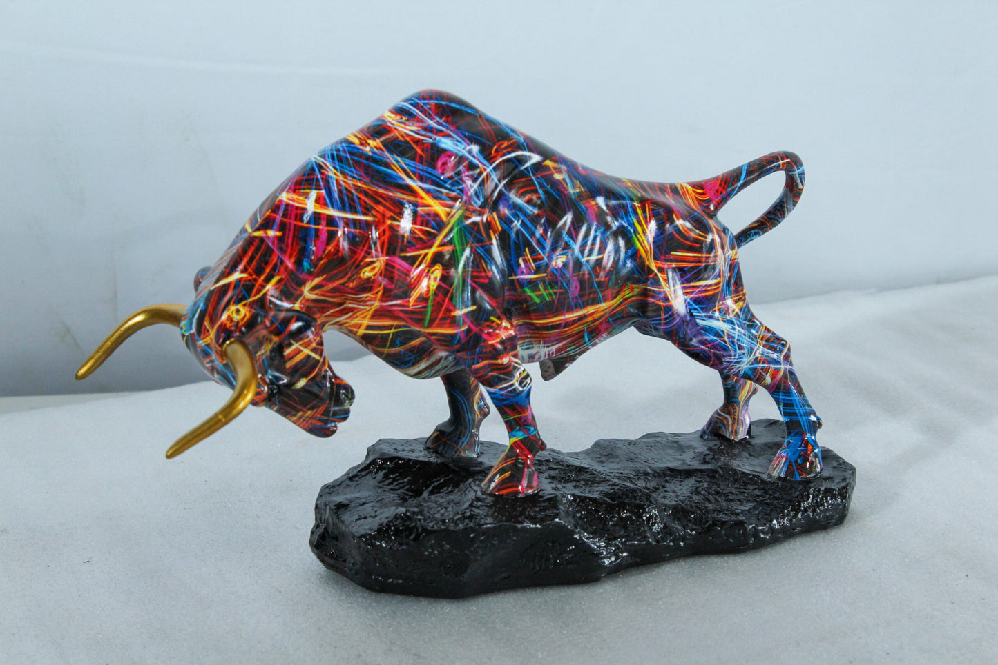 Nifao Resin Bull Statue - Multicolor Indoor/Outdoor Charging Bull SculptureRed,Blue,Yellow &Orange Design with Gold Horns on Glossy Black Base,Decorative Figurine for Homes,Offices14 x 4" x 9"H