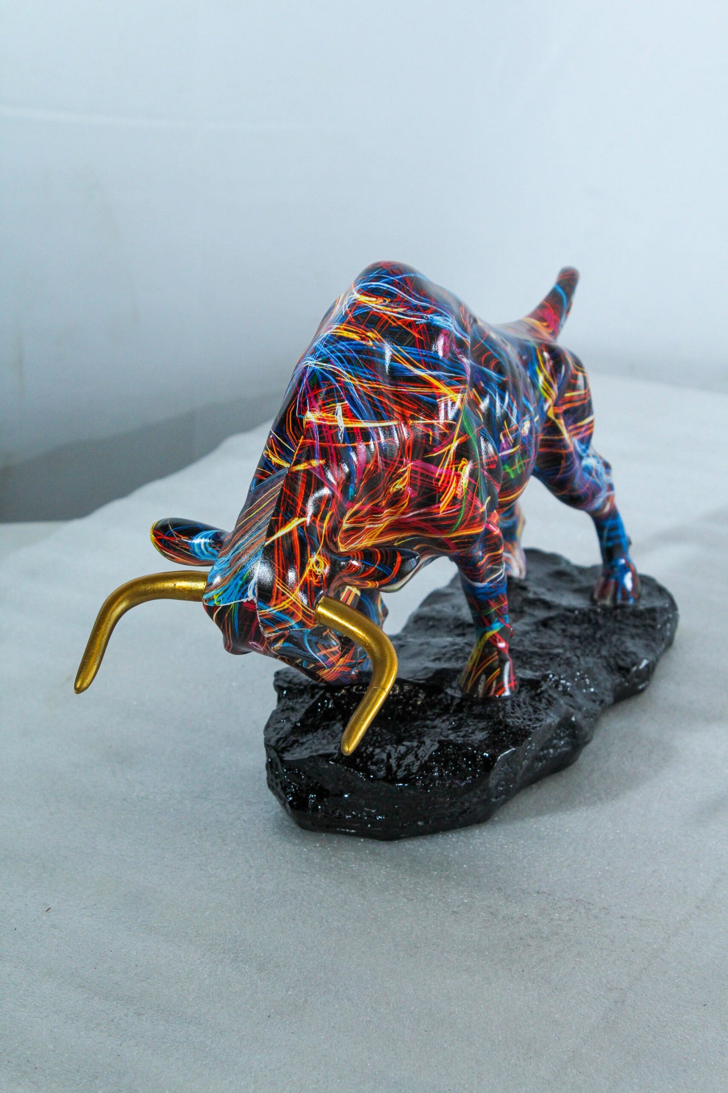Nifao Resin Bull Statue - Multicolor Indoor/Outdoor Charging Bull SculptureRed,Blue,Yellow &Orange Design with Gold Horns on Glossy Black Base,Decorative Figurine for Homes,Offices14 x 4" x 9"H
