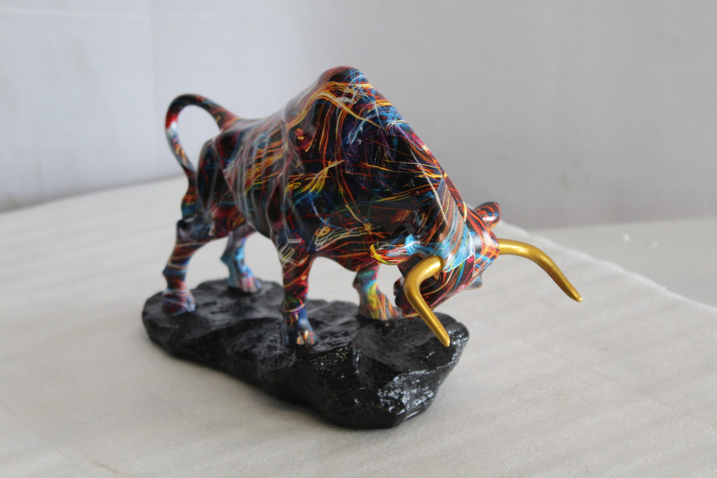 Nifao Resin Bull Statue - Multicolor Indoor/Outdoor Charging Bull SculptureRed,Blue,Yellow &Orange Design with Gold Horns on Glossy Black Base,Decorative Figurine for Homes,Offices14 x 4" x 9"H