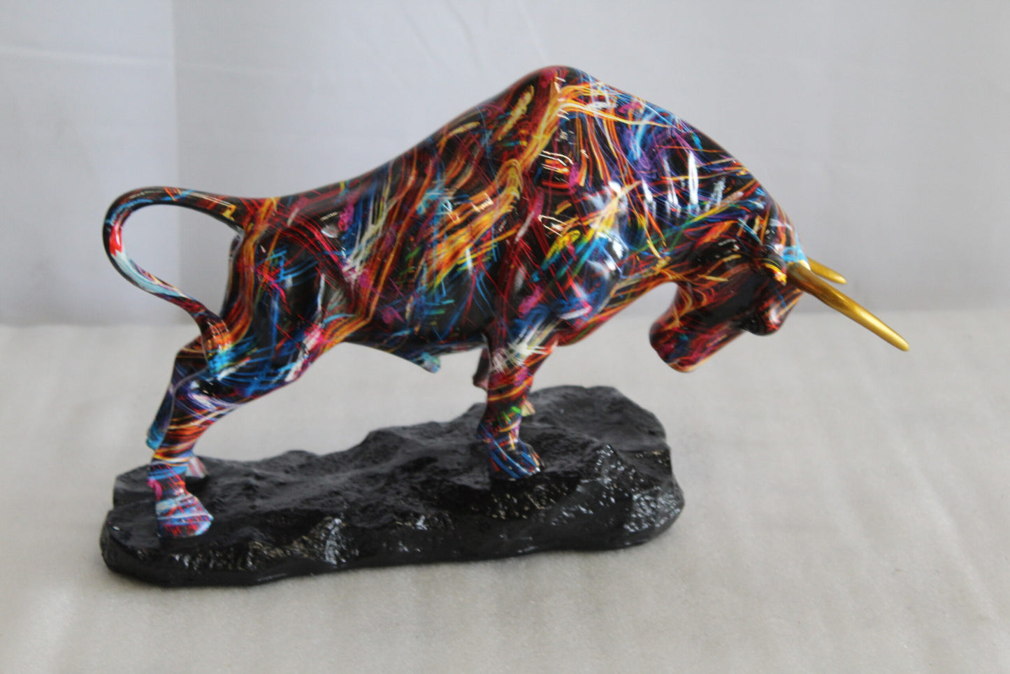 Nifao Resin Bull Statue - Multicolor Indoor/Outdoor Charging Bull SculptureRed,Blue,Yellow &Orange Design with Gold Horns on Glossy Black Base,Decorative Figurine for Homes,Offices14 x 4" x 9"H