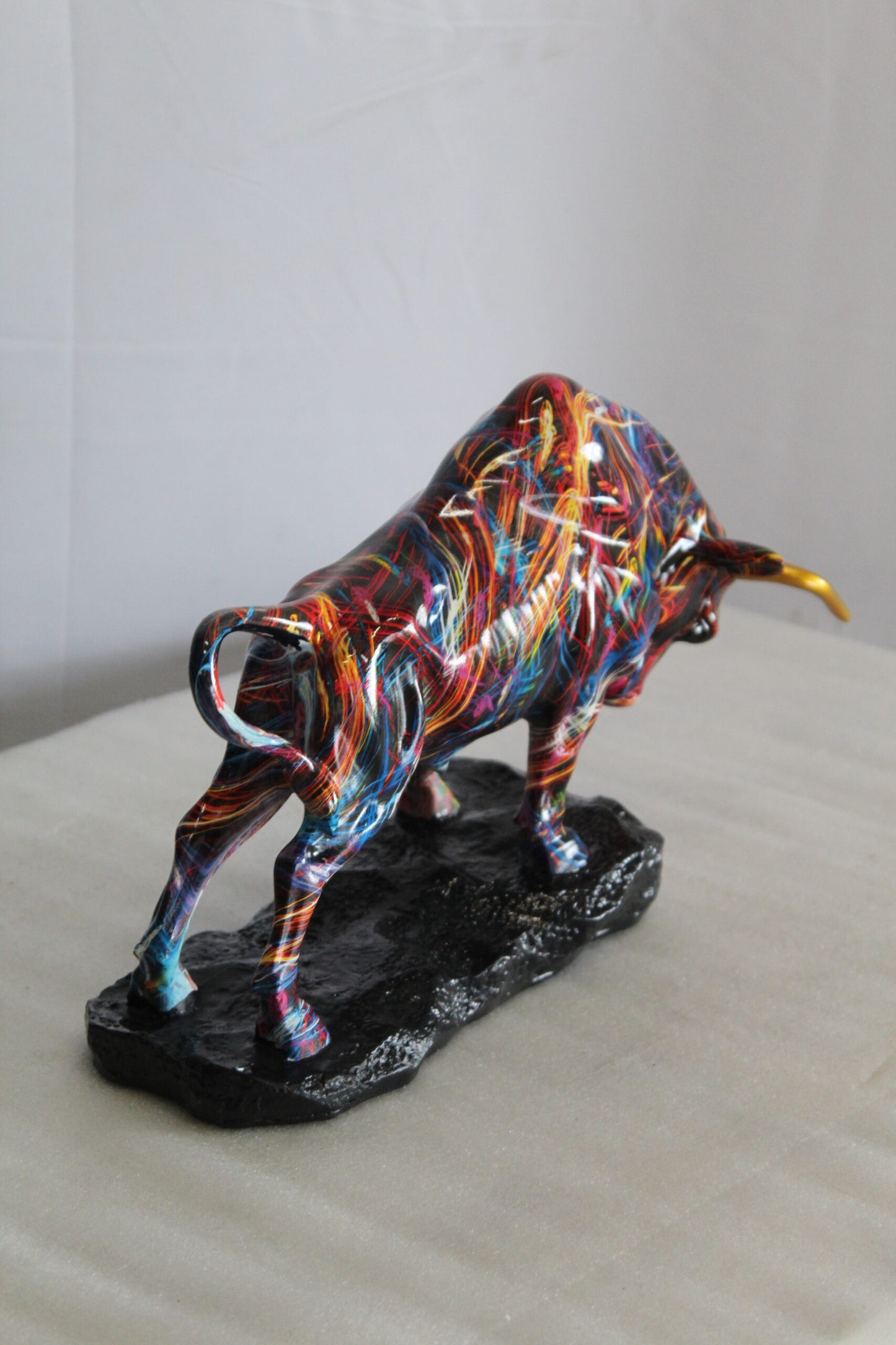 Nifao Resin Bull Statue - Multicolor Indoor/Outdoor Charging Bull SculptureRed,Blue,Yellow &Orange Design with Gold Horns on Glossy Black Base,Decorative Figurine for Homes,Offices14 x 4" x 9"H