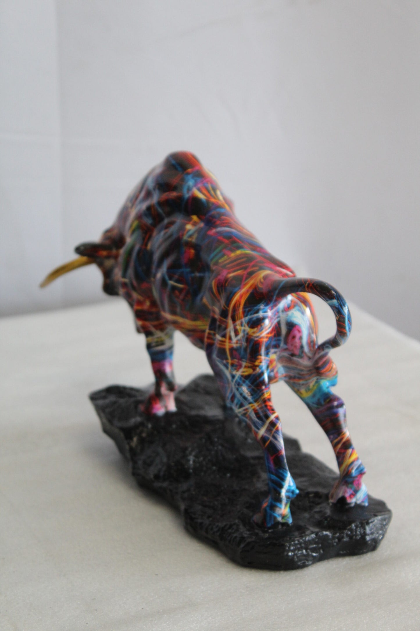 Nifao Resin Bull Statue - Multicolor Indoor/Outdoor Charging Bull SculptureRed,Blue,Yellow &Orange Design with Gold Horns on Glossy Black Base,Decorative Figurine for Homes,Offices14 x 4" x 9"H