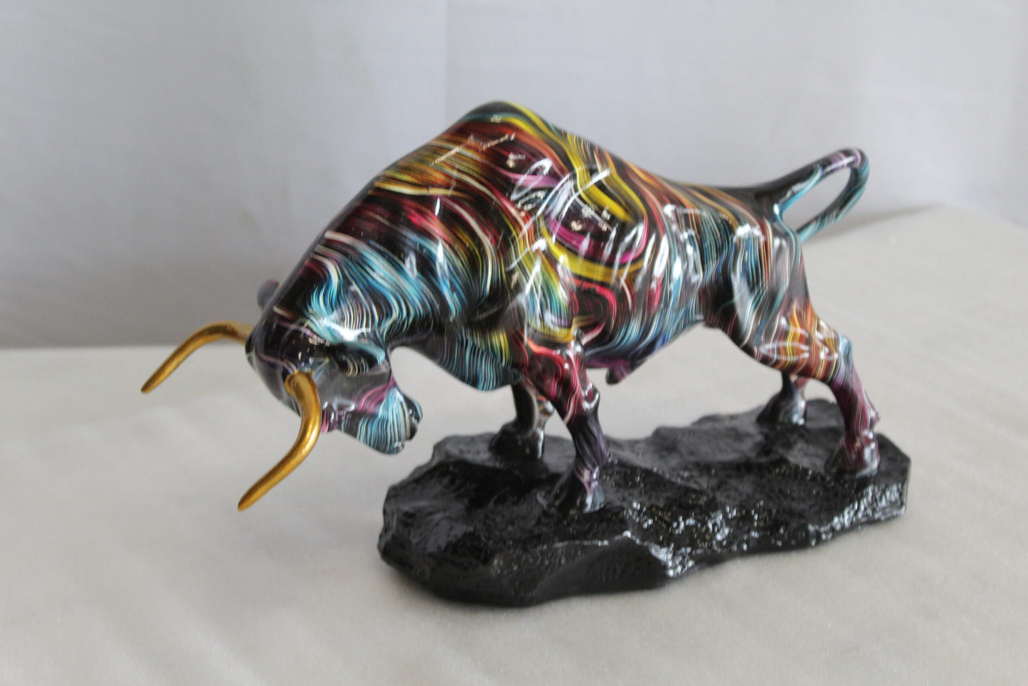 Nifao Resin Bull Statue- Multicolor Swirl Indoor/Outdoor Charging Bull Sculpture,Abstract Yellow,Blue,Red &Violet Design with Gold Horns on Glossy Black Base for Homes, Offices 14" x 4" x 9"H