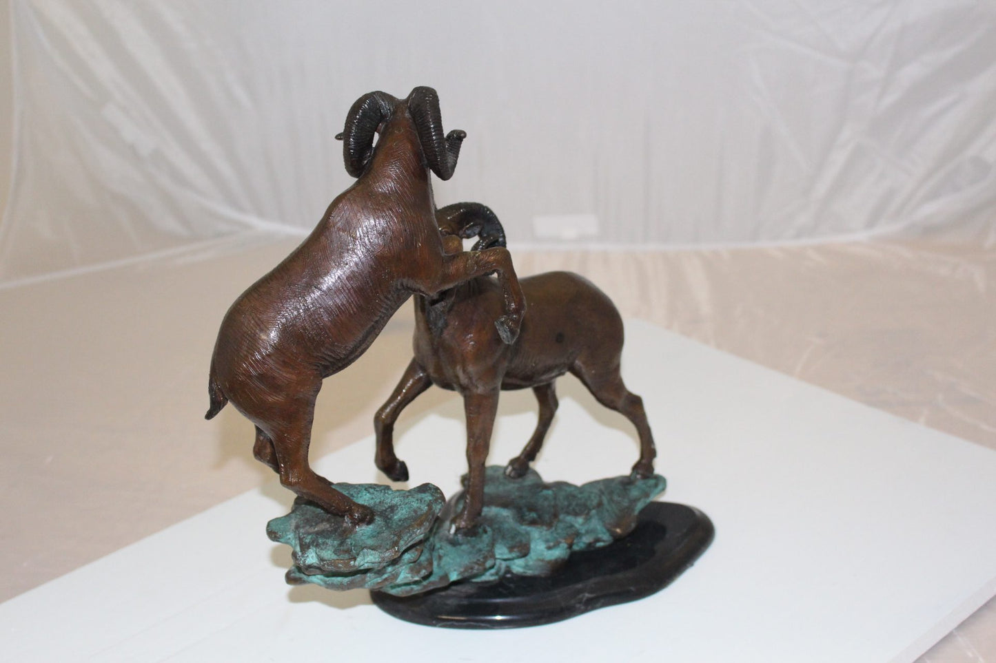 Two Rams on a rock Bronze Statue - Size: 15"L x 8"W x 16"H.