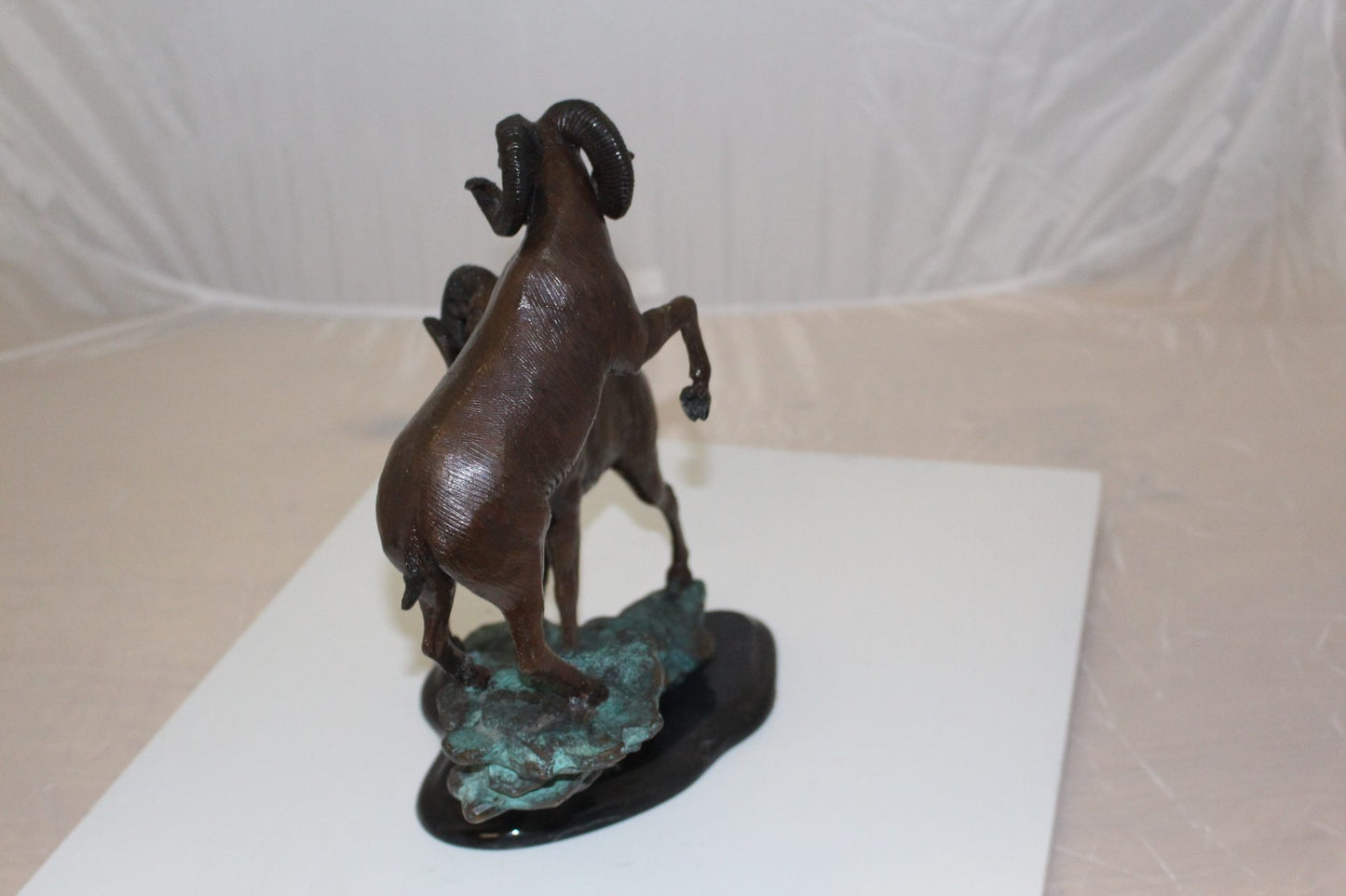 Two Rams on a rock Bronze Statue - Size: 15"L x 8"W x 16"H.