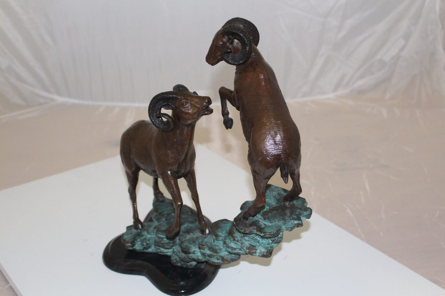 Two Rams on a rock Bronze Statue - Size: 15"L x 8"W x 16"H.